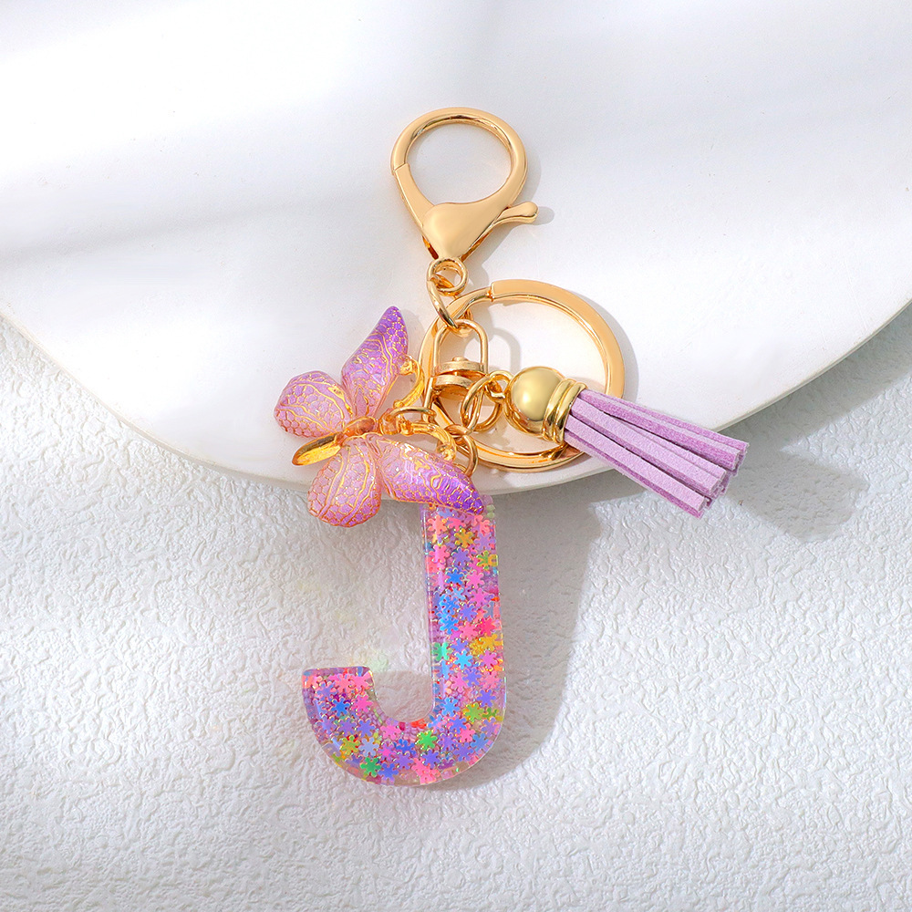 Wholesale purple snowflake sequined epoxy resin letter keychains, tassel butterfly pendants, decorations, and gifts.