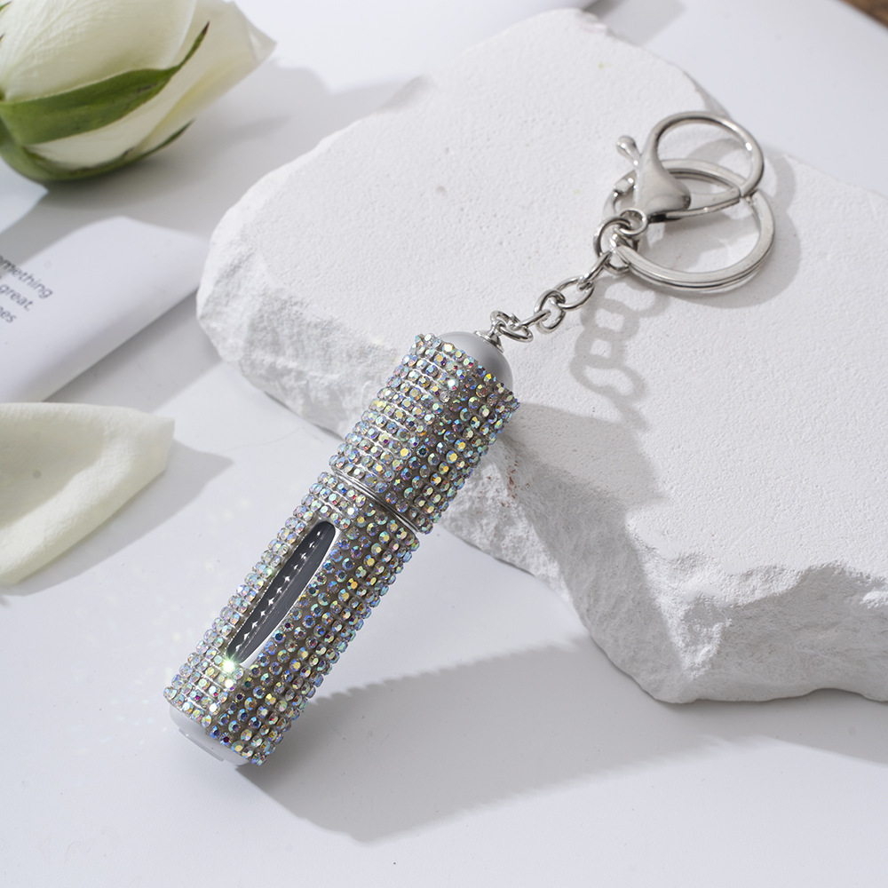 Amazon's popular rhinestone-embellished creative perfume dispenser keychain for women—portable, exquisite, stylish, and convenient.