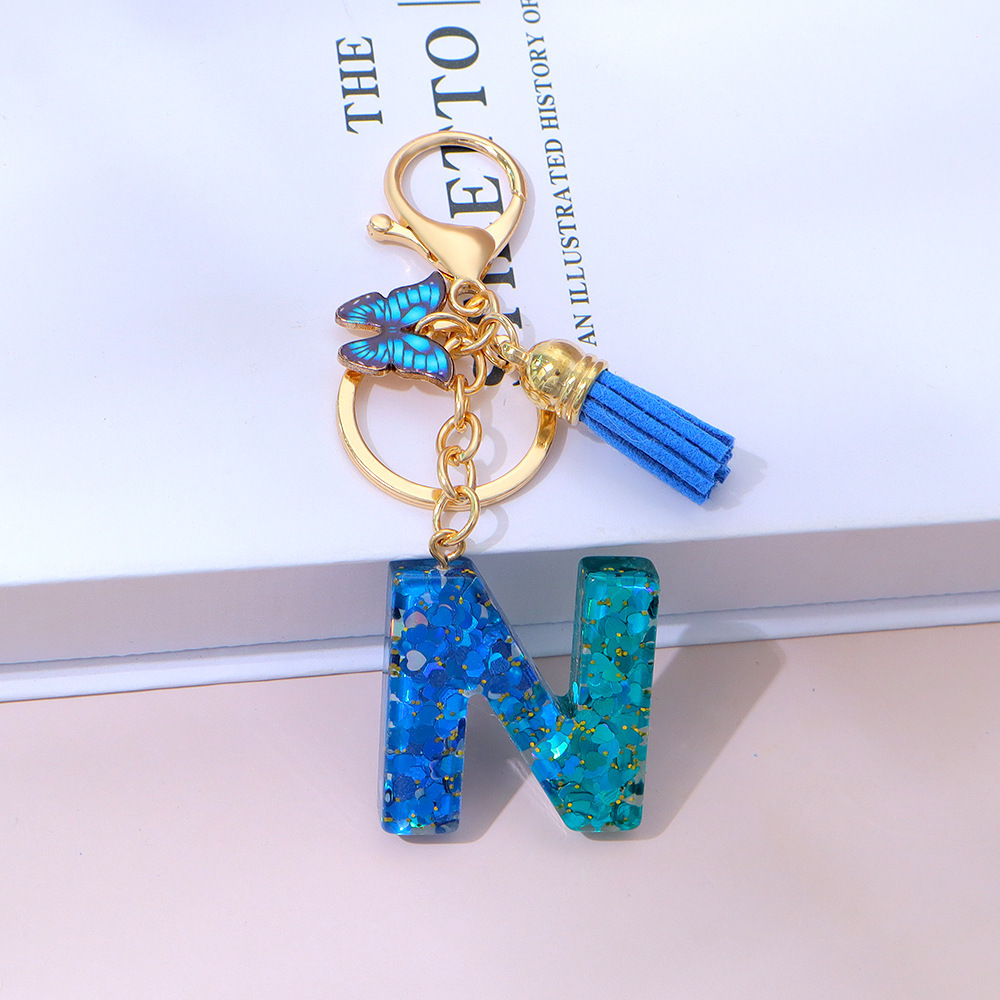 Wholesale blue gradient epoxy lettering, butterfly tassel pendants, women's bag charms, souvenirs.