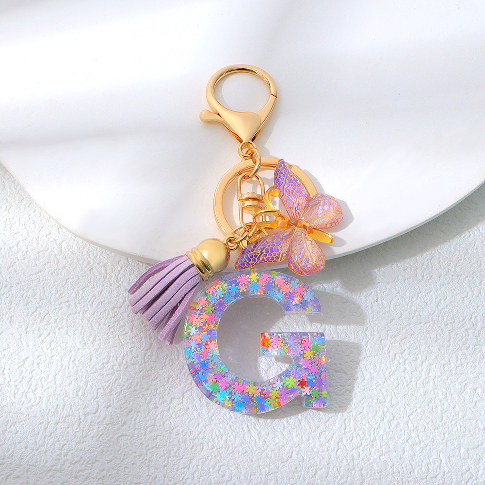 Wholesale purple snowflake sequined epoxy resin letter keychains, tassel butterfly pendants, decorations, and gifts.