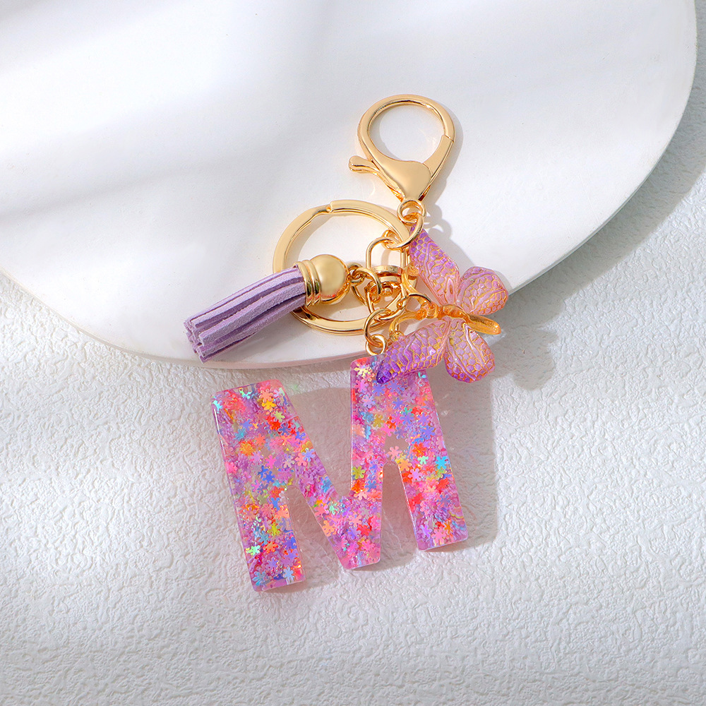 Wholesale purple snowflake sequined epoxy resin letter keychains, tassel butterfly pendants, decorations, and gifts.