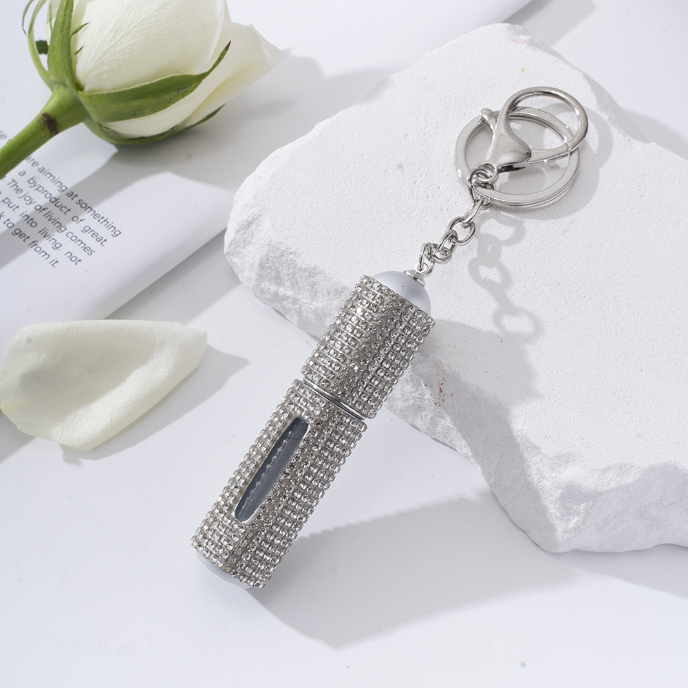 Amazon's popular rhinestone-embellished creative perfume dispenser keychain for women—portable, exquisite, stylish, and convenient.