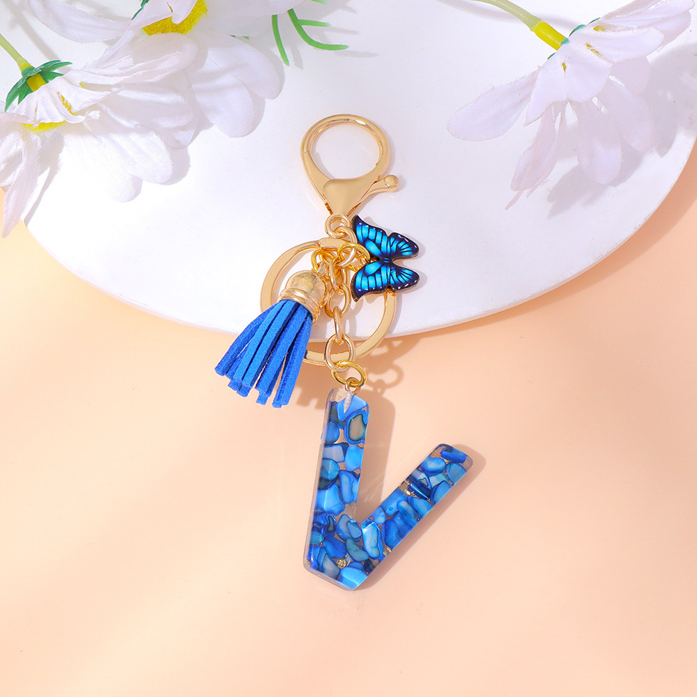 Wholesale blue stone gold foil English letter keychains, tassel butterflies, women's bag charms, souvenirs.