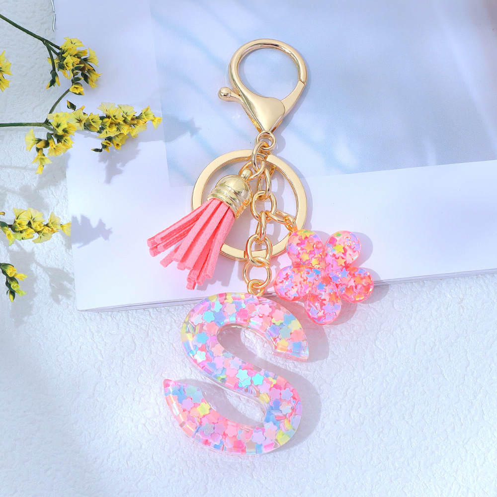 Wholesale pink star sequined epoxy resin letter keychains, flower pendants, DIY bag charms, perfect for gifting to your best friend.