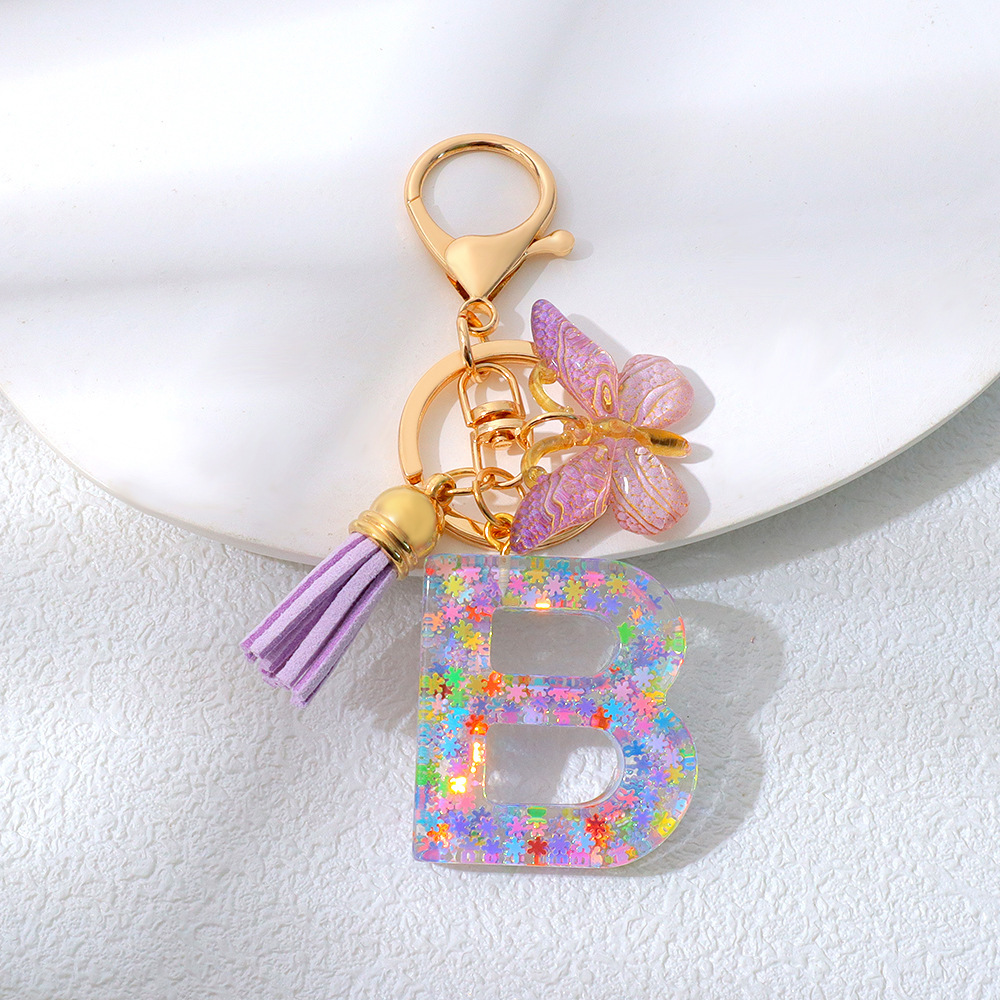 Wholesale purple snowflake sequined epoxy resin letter keychains, tassel butterfly pendants, decorations, and gifts.
