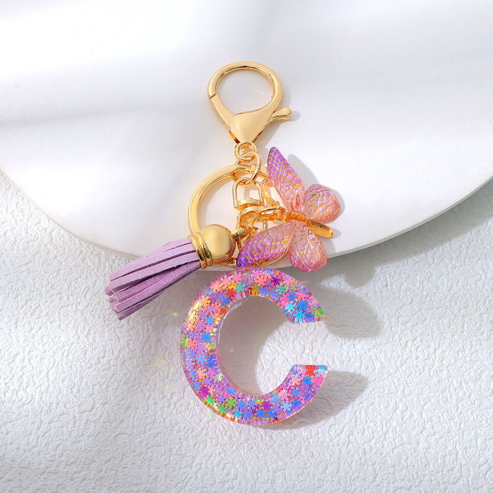 Wholesale purple snowflake sequined epoxy resin letter keychains, tassel butterfly pendants, decorations, and gifts.