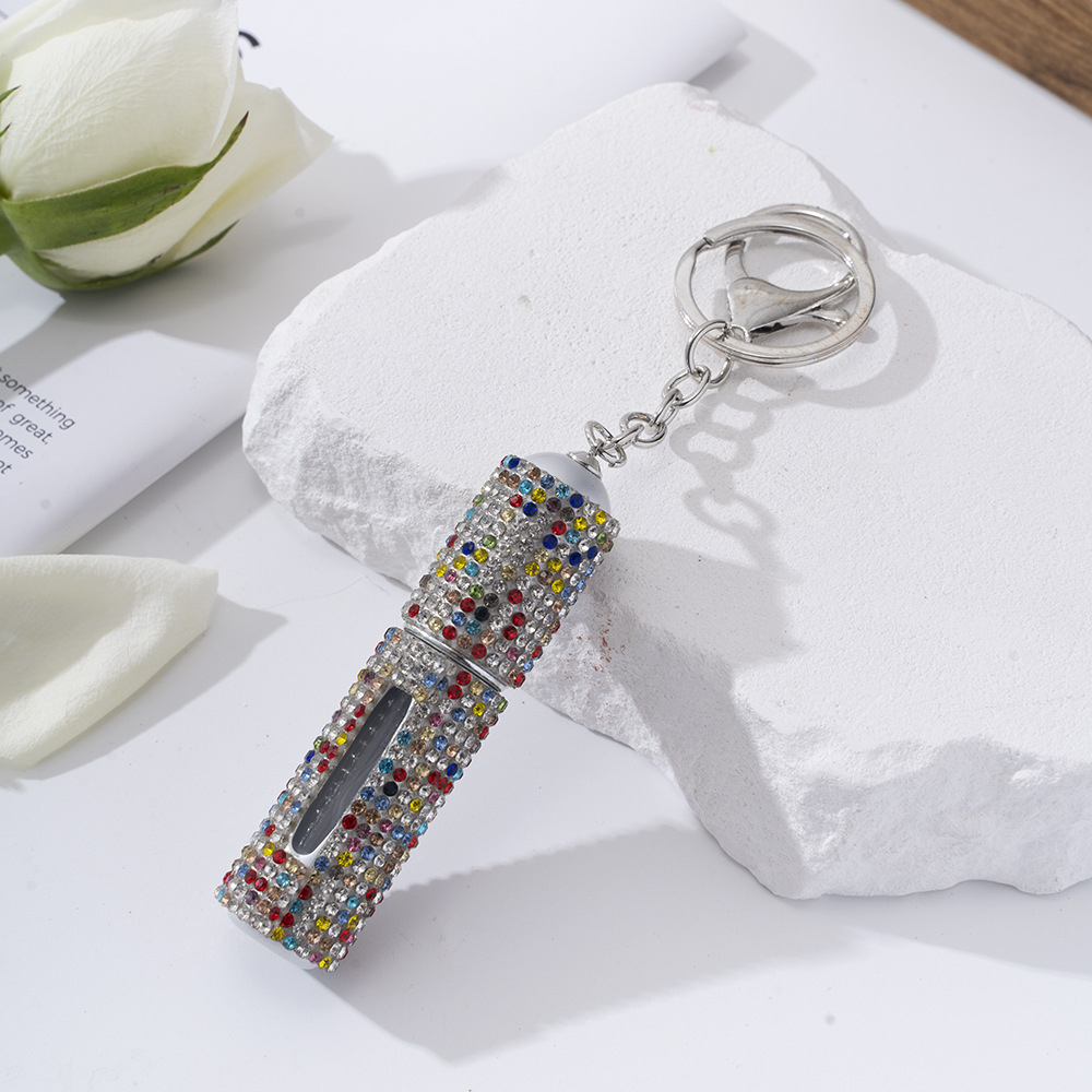 Amazon's popular rhinestone-embellished creative perfume dispenser keychain for women—portable, exquisite, stylish, and convenient.