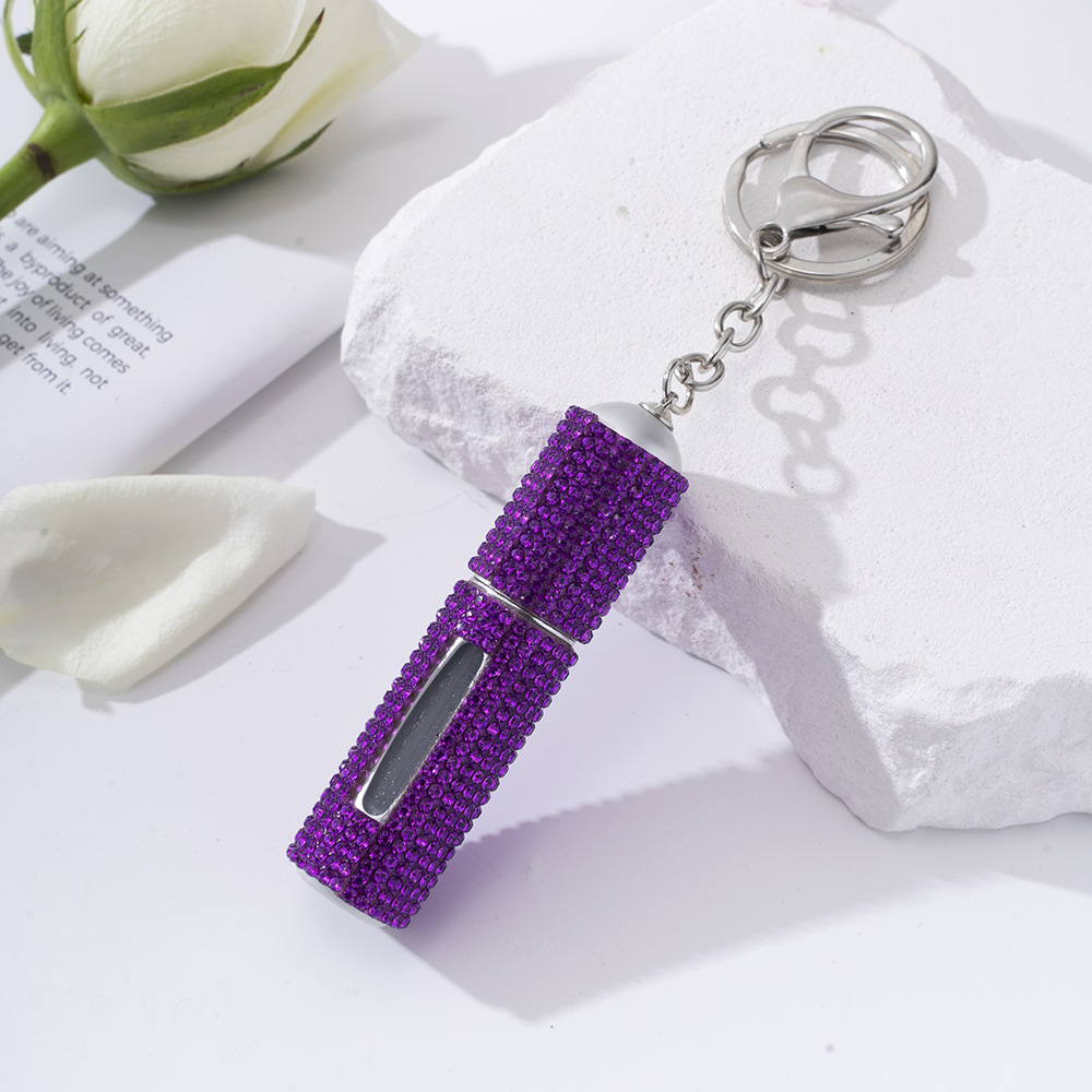 Amazon's popular rhinestone-embellished creative perfume dispenser keychain for women—portable, exquisite, stylish, and convenient.