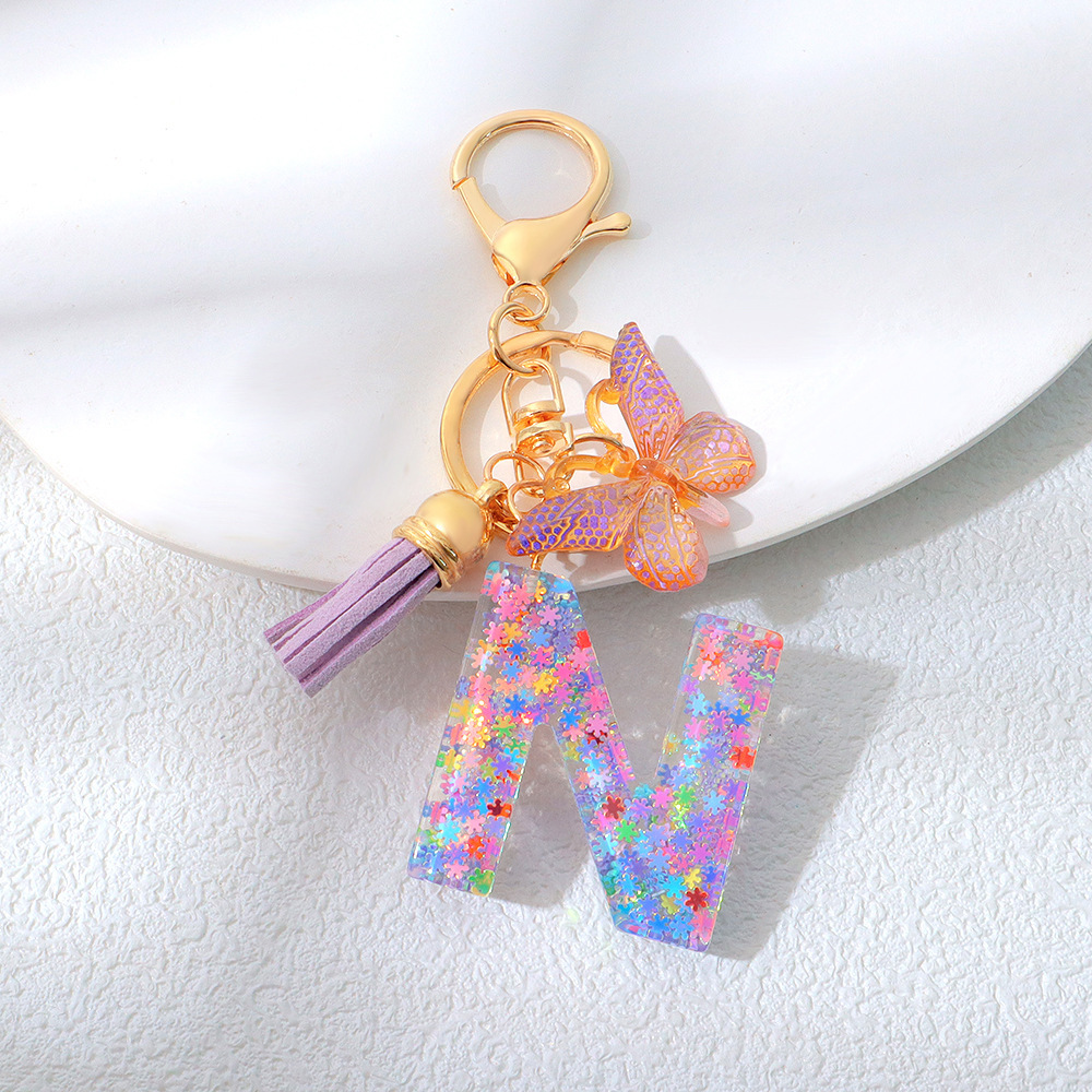 Wholesale purple snowflake sequined epoxy resin letter keychains, tassel butterfly pendants, decorations, and gifts.