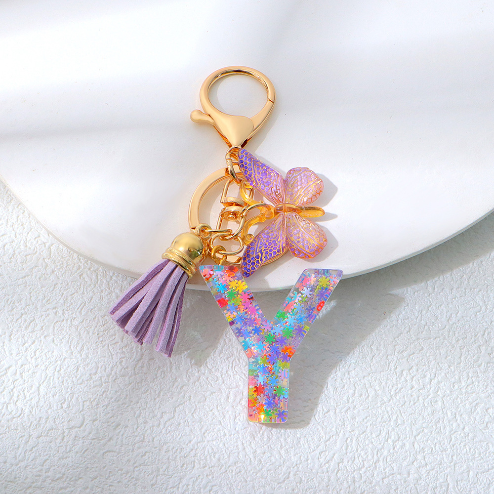 Wholesale purple snowflake sequined epoxy resin letter keychains, tassel butterfly pendants, decorations, and gifts.