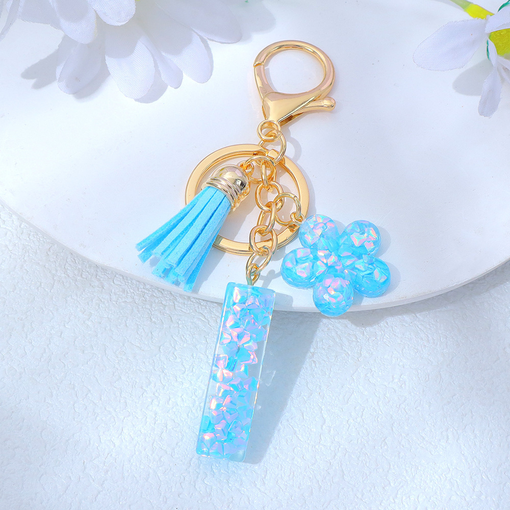 Wholesale blue crystal epoxy letter keychains, letter pendants, flower charms, and bag decorations.