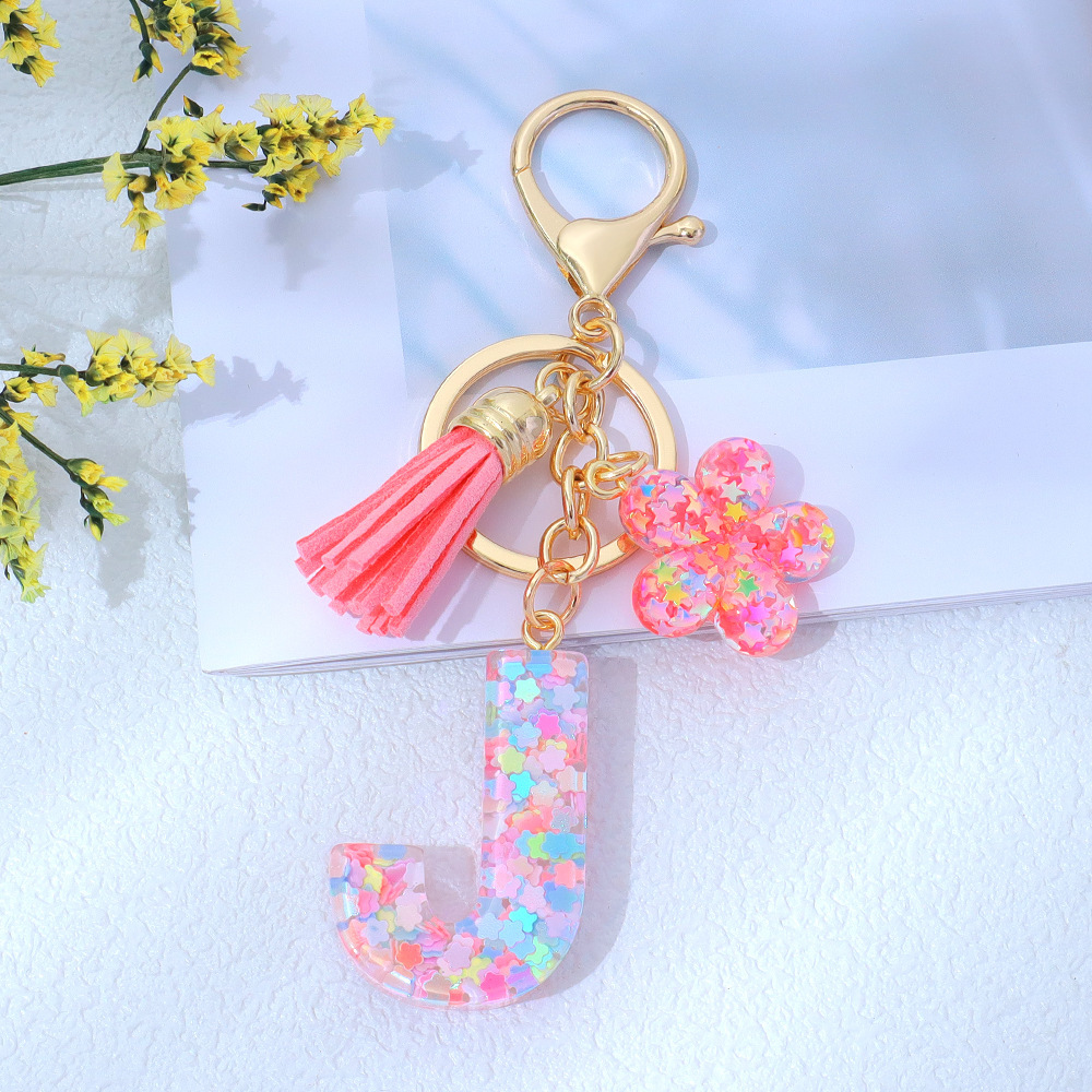 Wholesale pink star sequined epoxy resin letter keychains, flower pendants, DIY bag charms, perfect for gifting to your best friend.