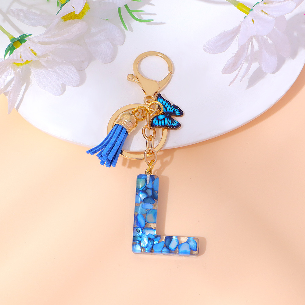 Wholesale blue stone gold foil English letter keychains, tassel butterflies, women's bag charms, souvenirs.