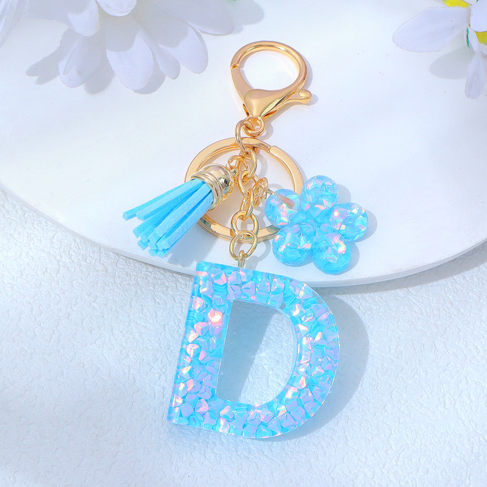 Wholesale blue crystal epoxy letter keychains, letter pendants, flower charms, and bag decorations.