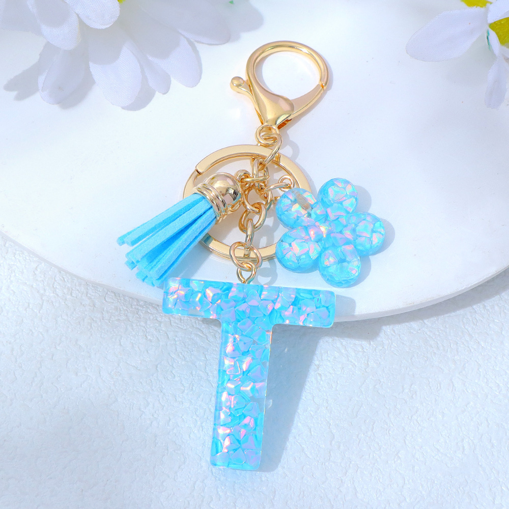 Wholesale blue crystal epoxy letter keychains, letter pendants, flower charms, and bag decorations.