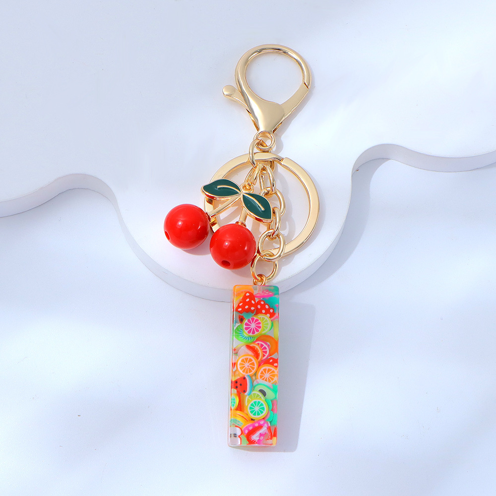 Wholesale fruit sequined letter keychains, resin tassel pendants, and women's bag charms.