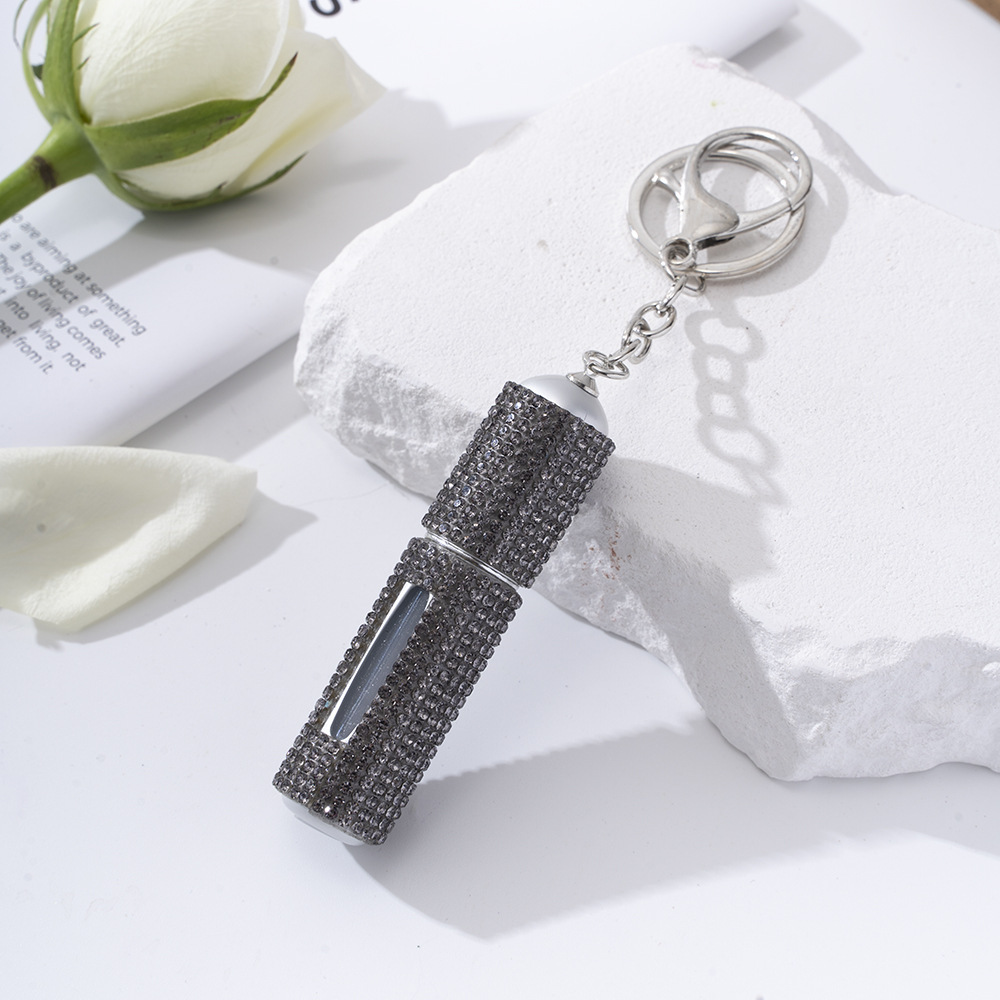 Amazon's popular rhinestone-embellished creative perfume dispenser keychain for women—portable, exquisite, stylish, and convenient.