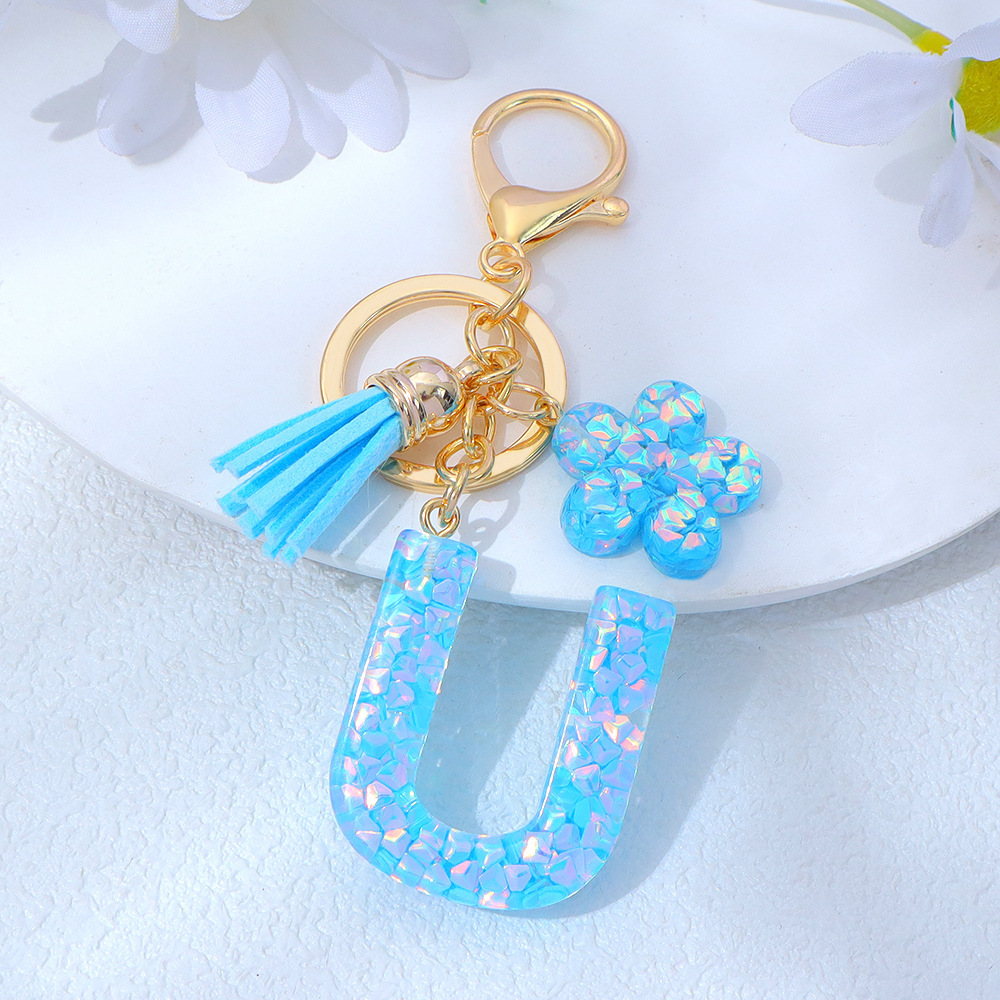 Wholesale blue crystal epoxy letter keychains, letter pendants, flower charms, and bag decorations.