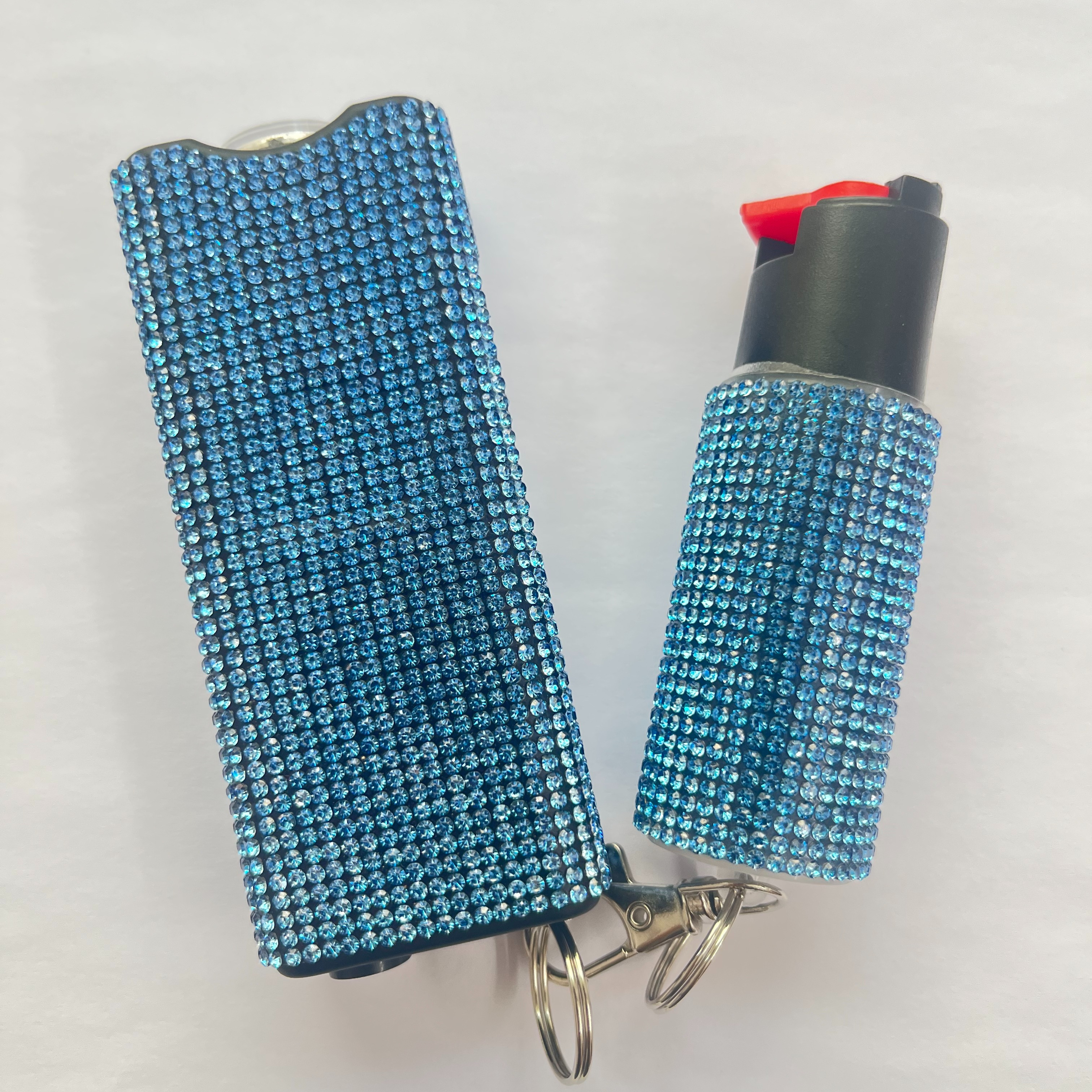 Self-defense multi-functional flashlight + spray keychain set for women.