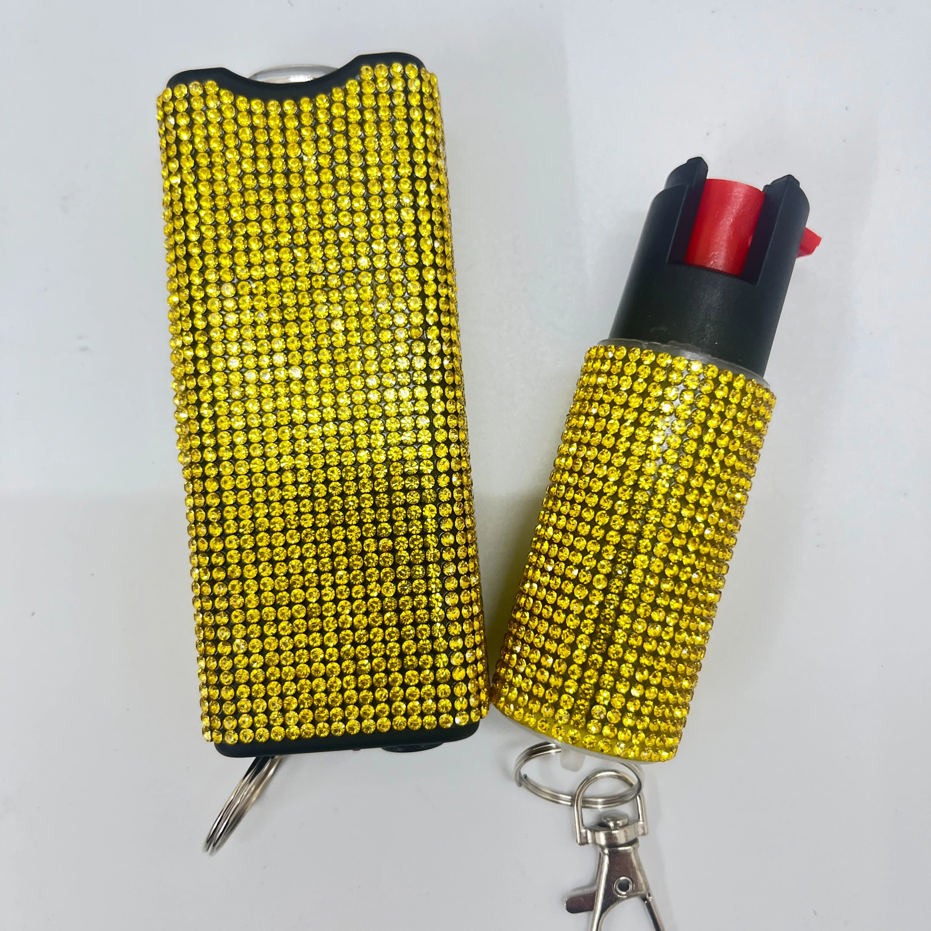 Self-defense multi-functional flashlight + spray keychain set for women.