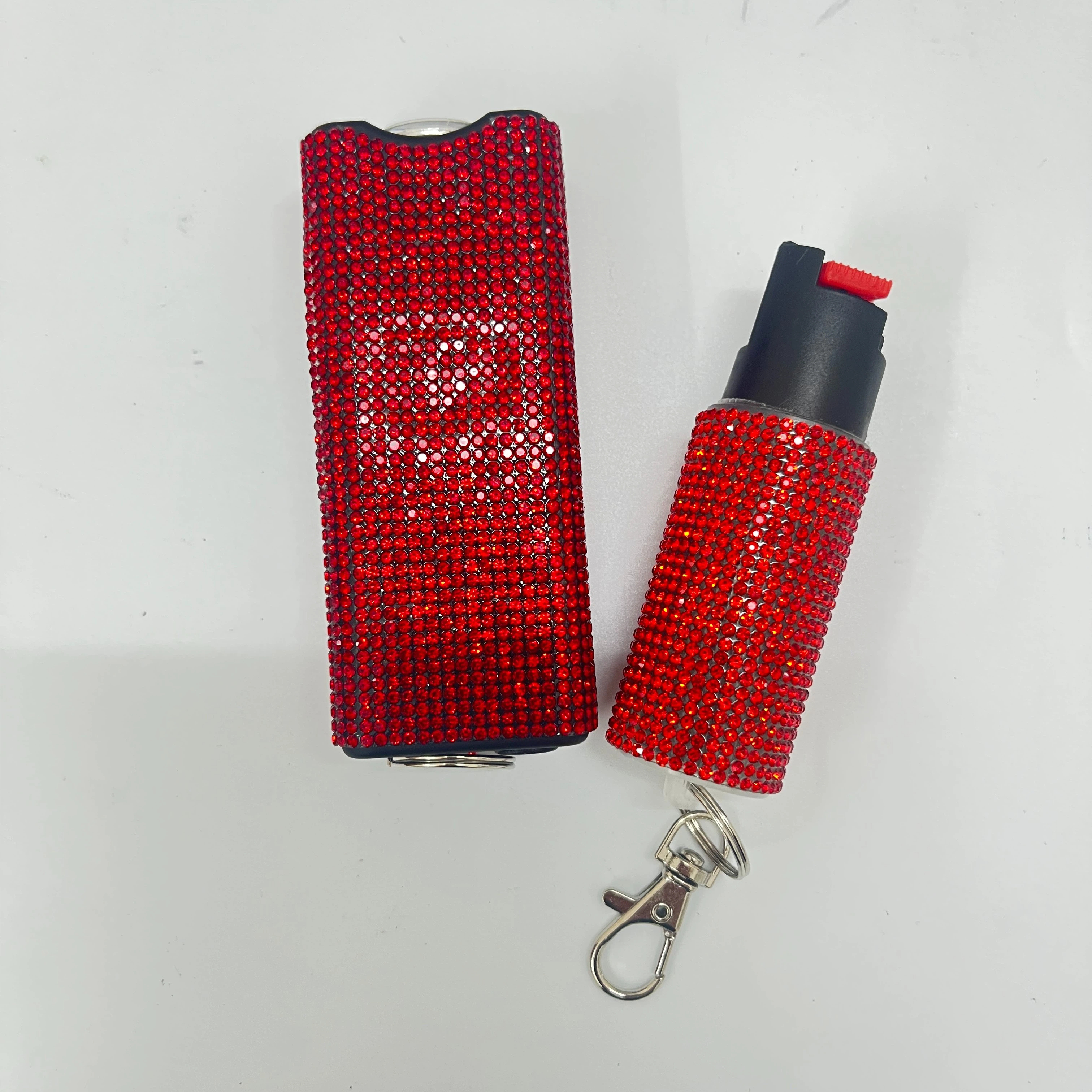 Self-defense multi-functional flashlight + spray keychain set for women.