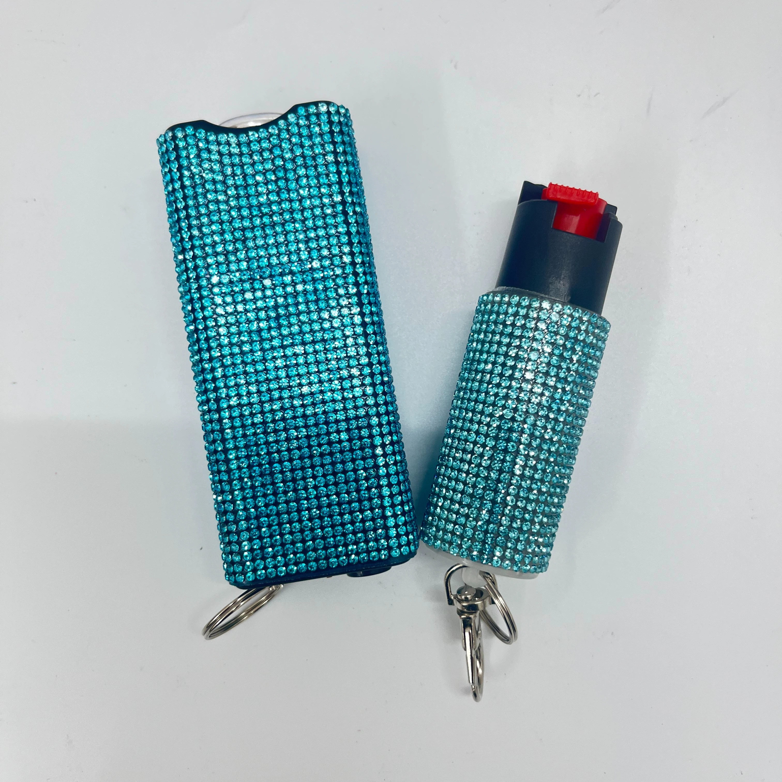 Self-defense multi-functional flashlight + spray keychain set for women.