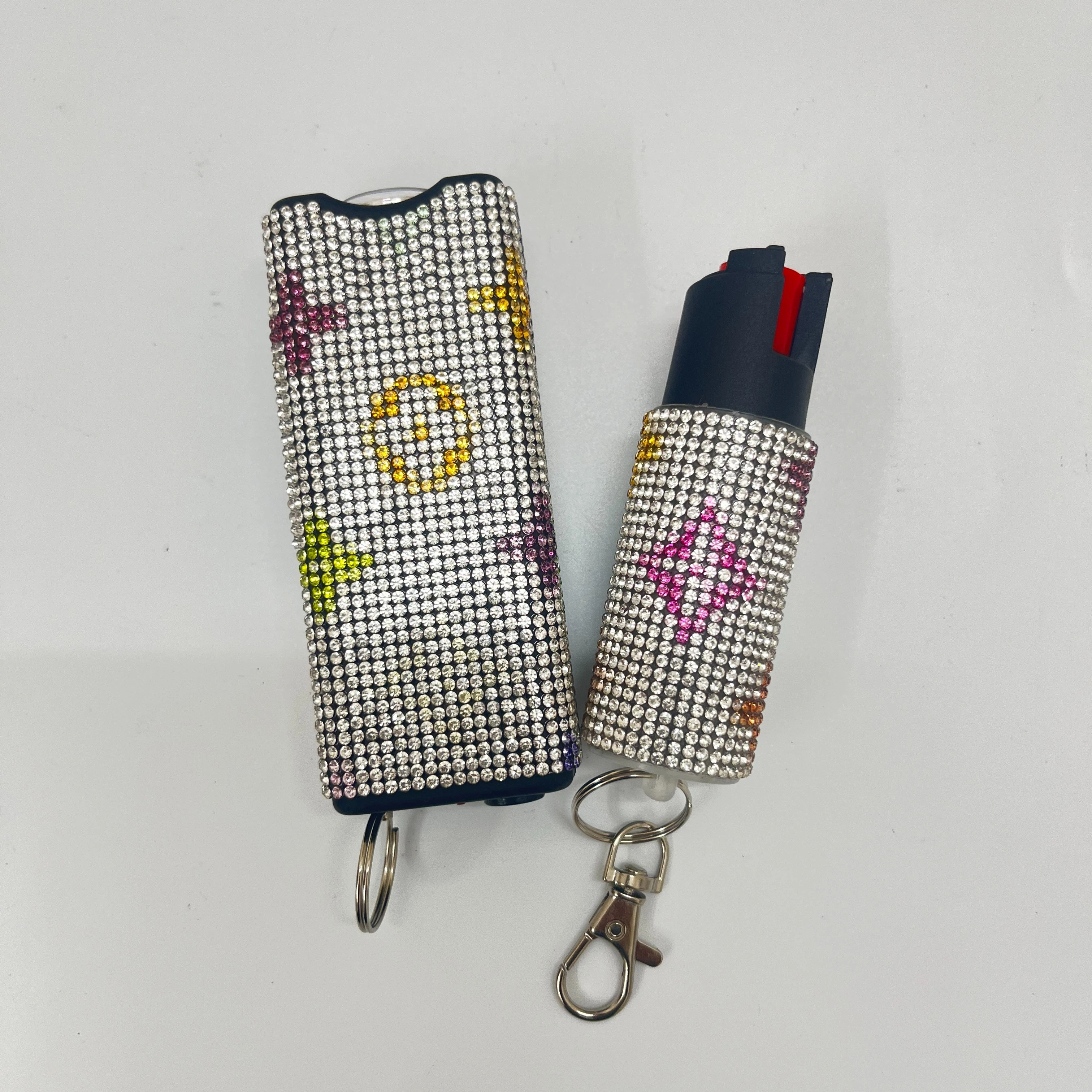 Self-defense multi-functional flashlight + spray keychain set for women.