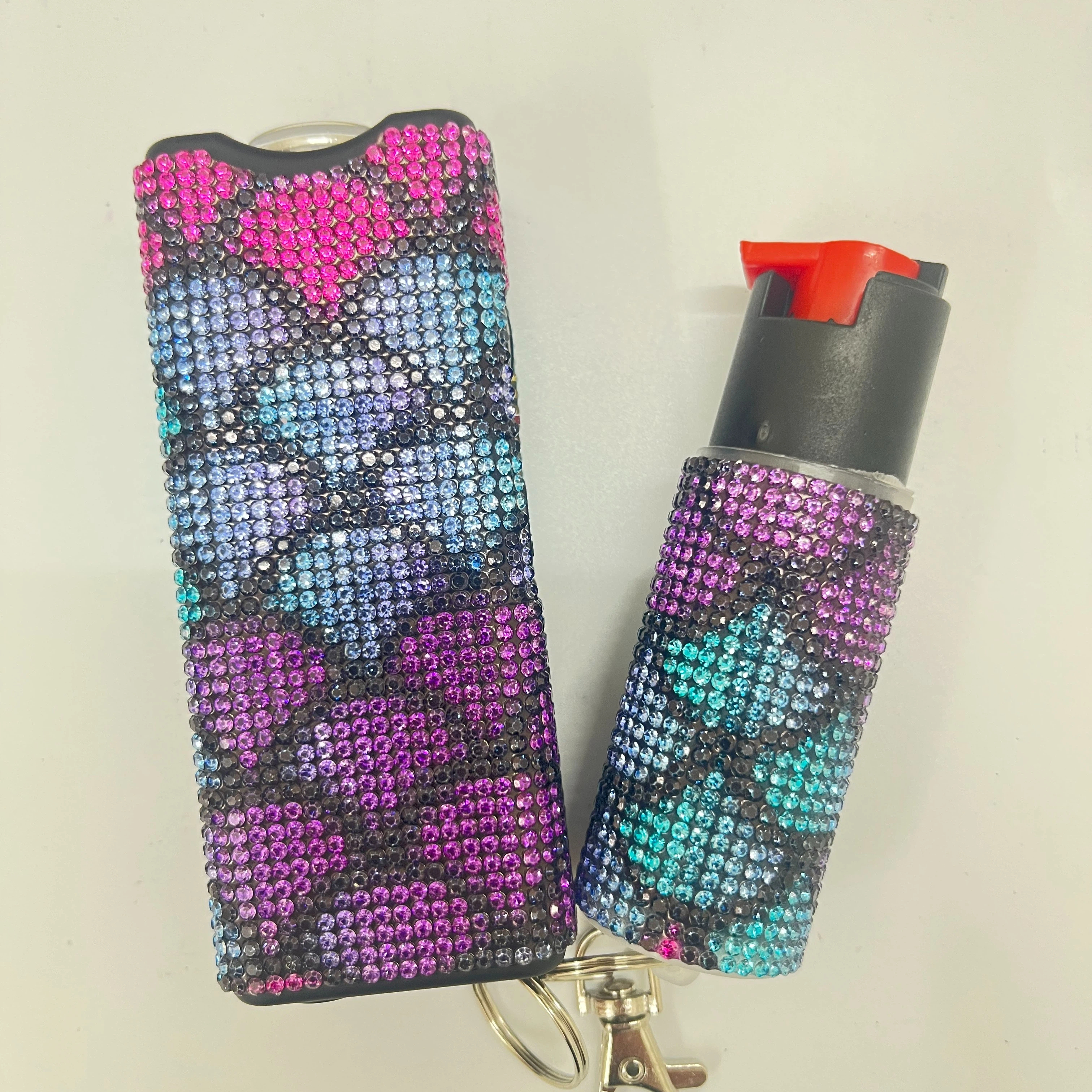 Self-defense multi-functional flashlight + spray keychain set for women.