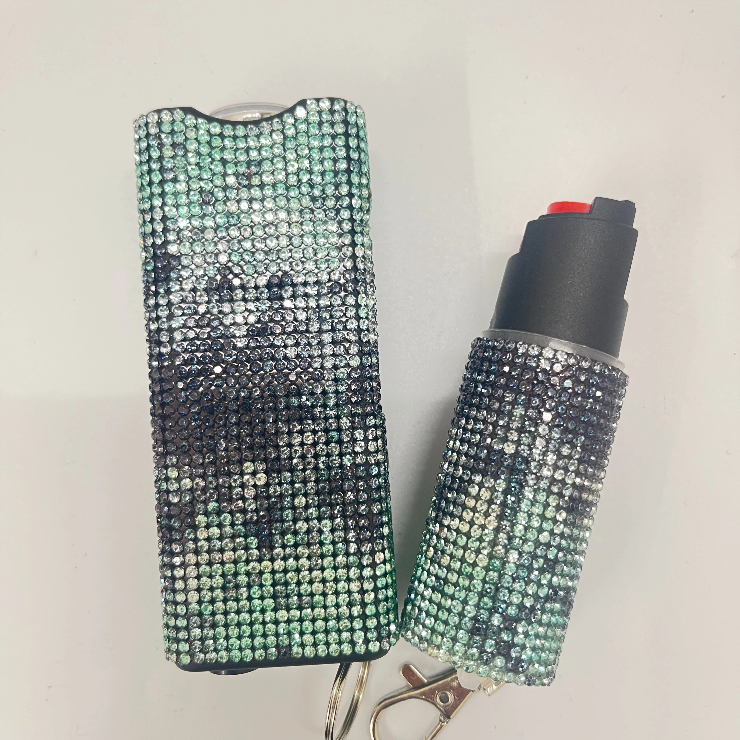 Self-defense multi-functional flashlight + spray keychain set for women.