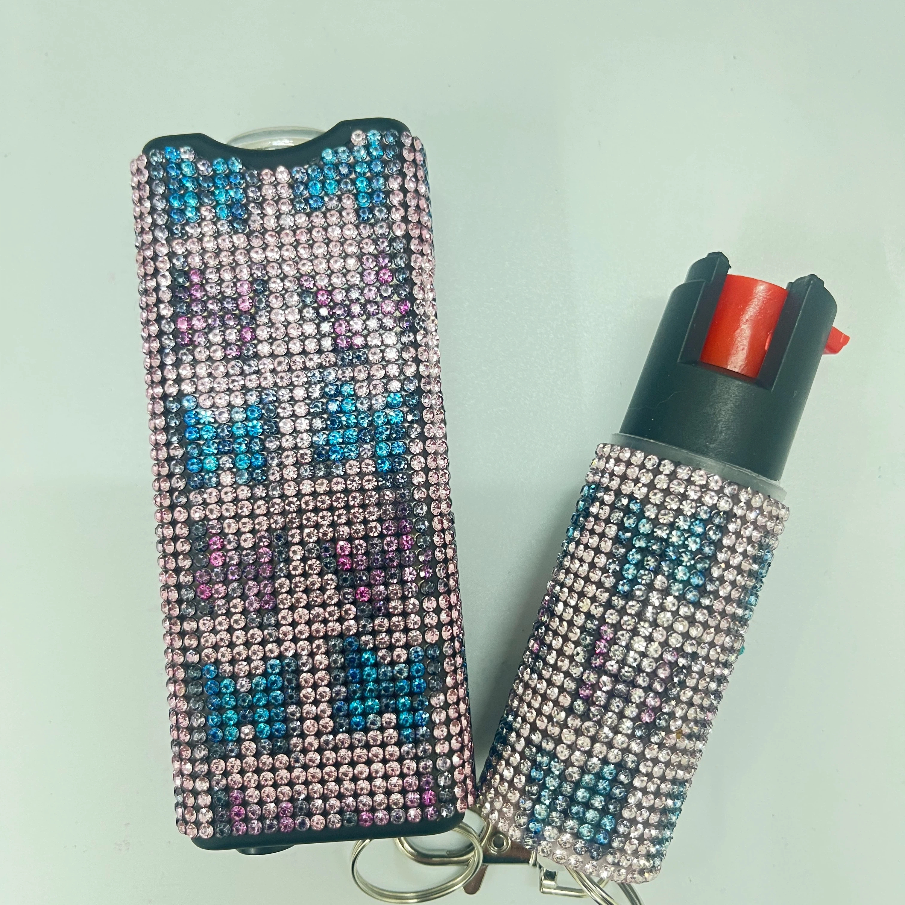 Self-defense multi-functional flashlight + spray keychain set for women.
