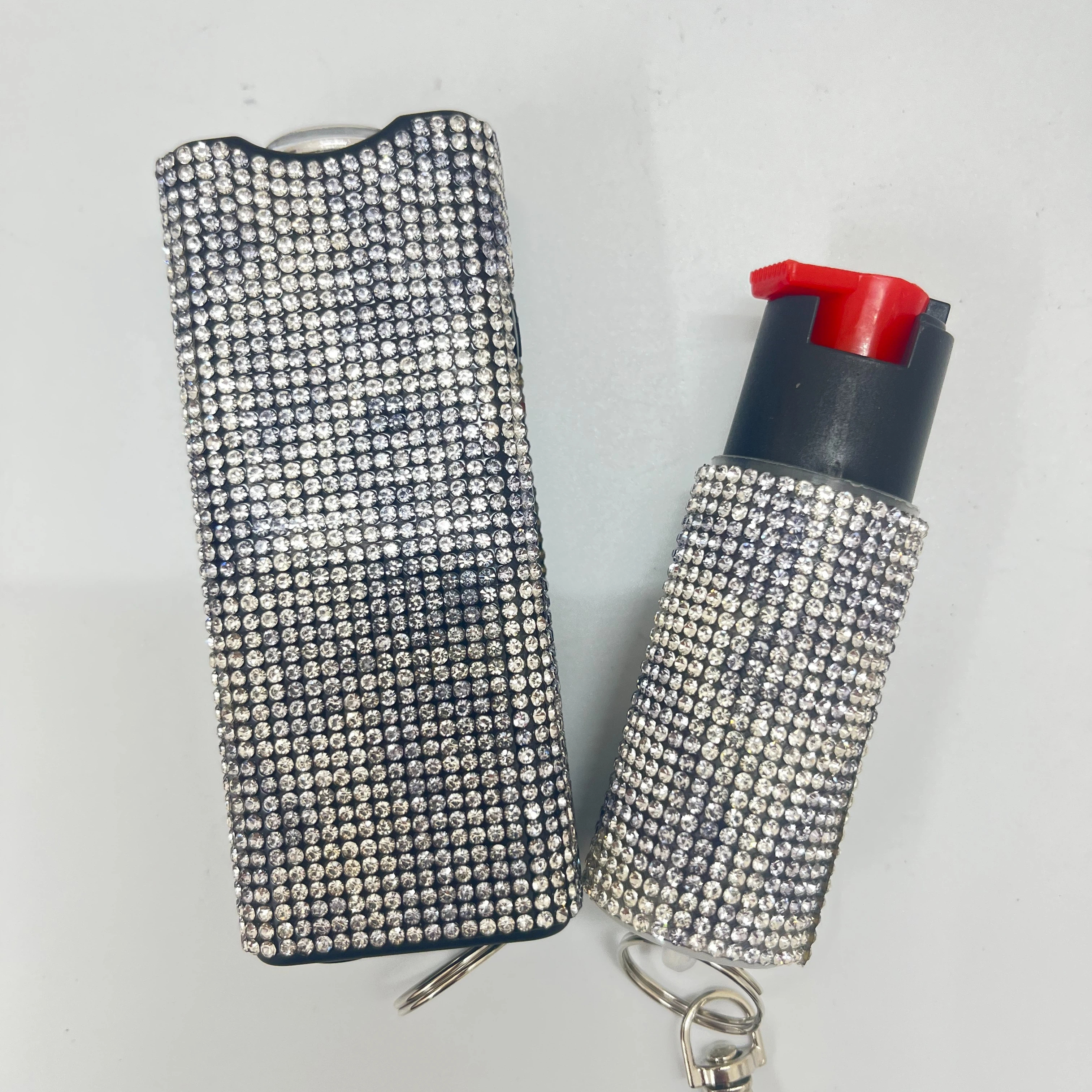 Self-defense multi-functional flashlight + spray keychain set for women.
