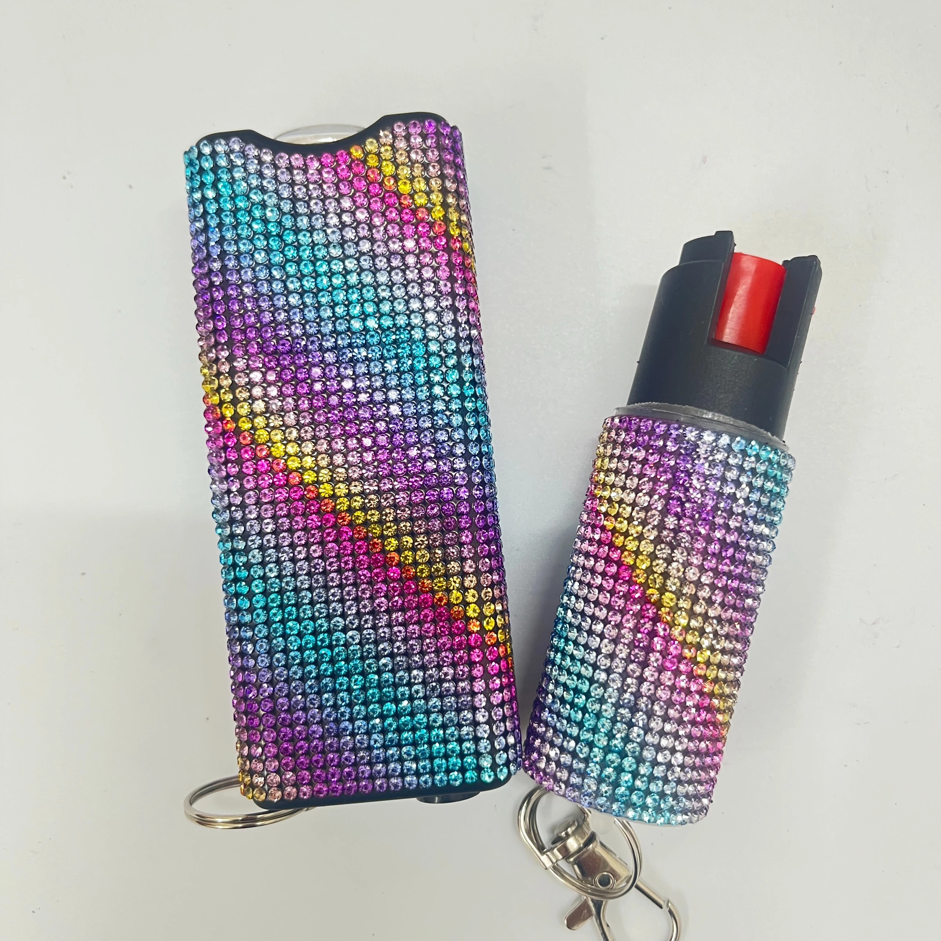 Self-defense multi-functional flashlight + spray keychain set for women.
