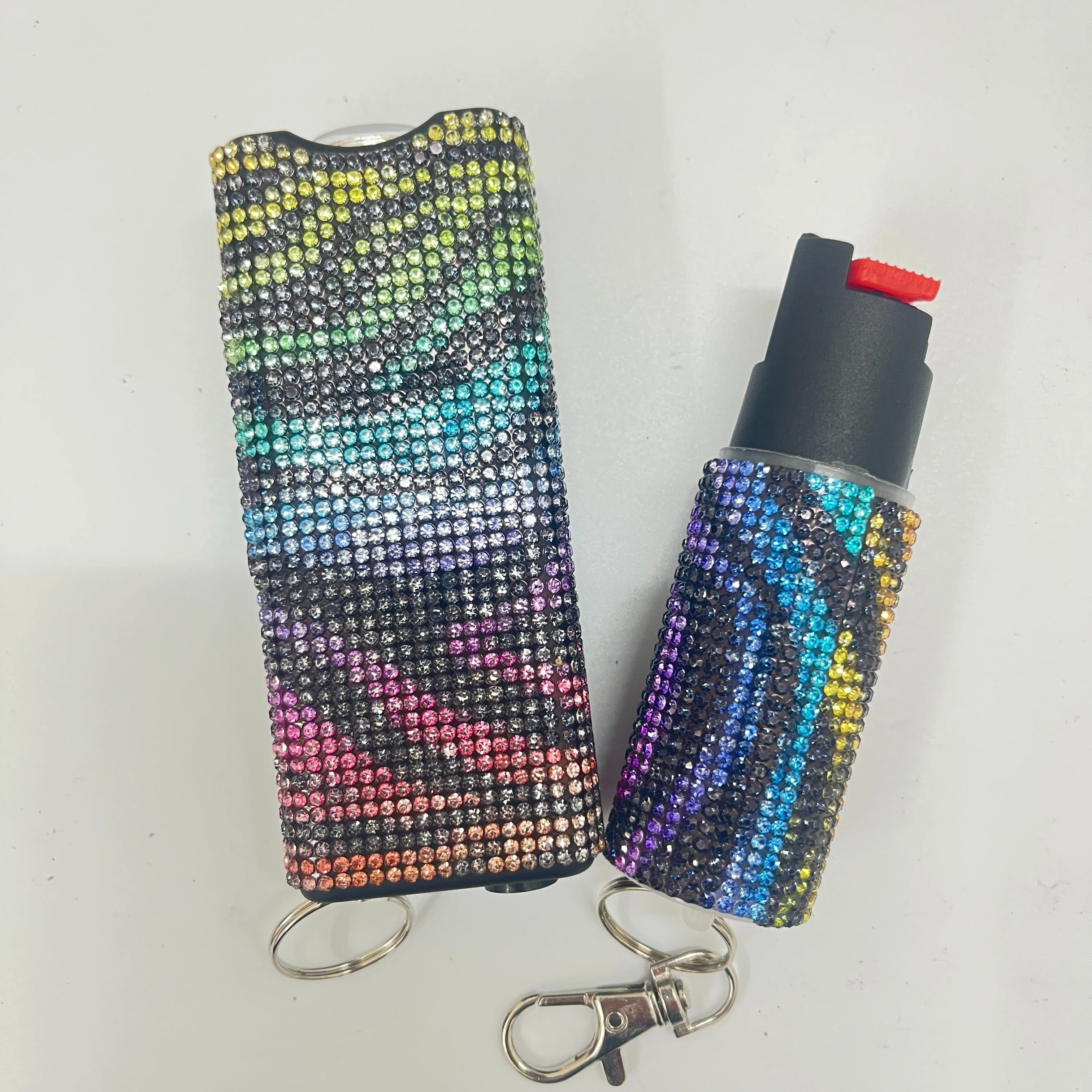 Self-defense multi-functional flashlight + spray keychain set for women.
