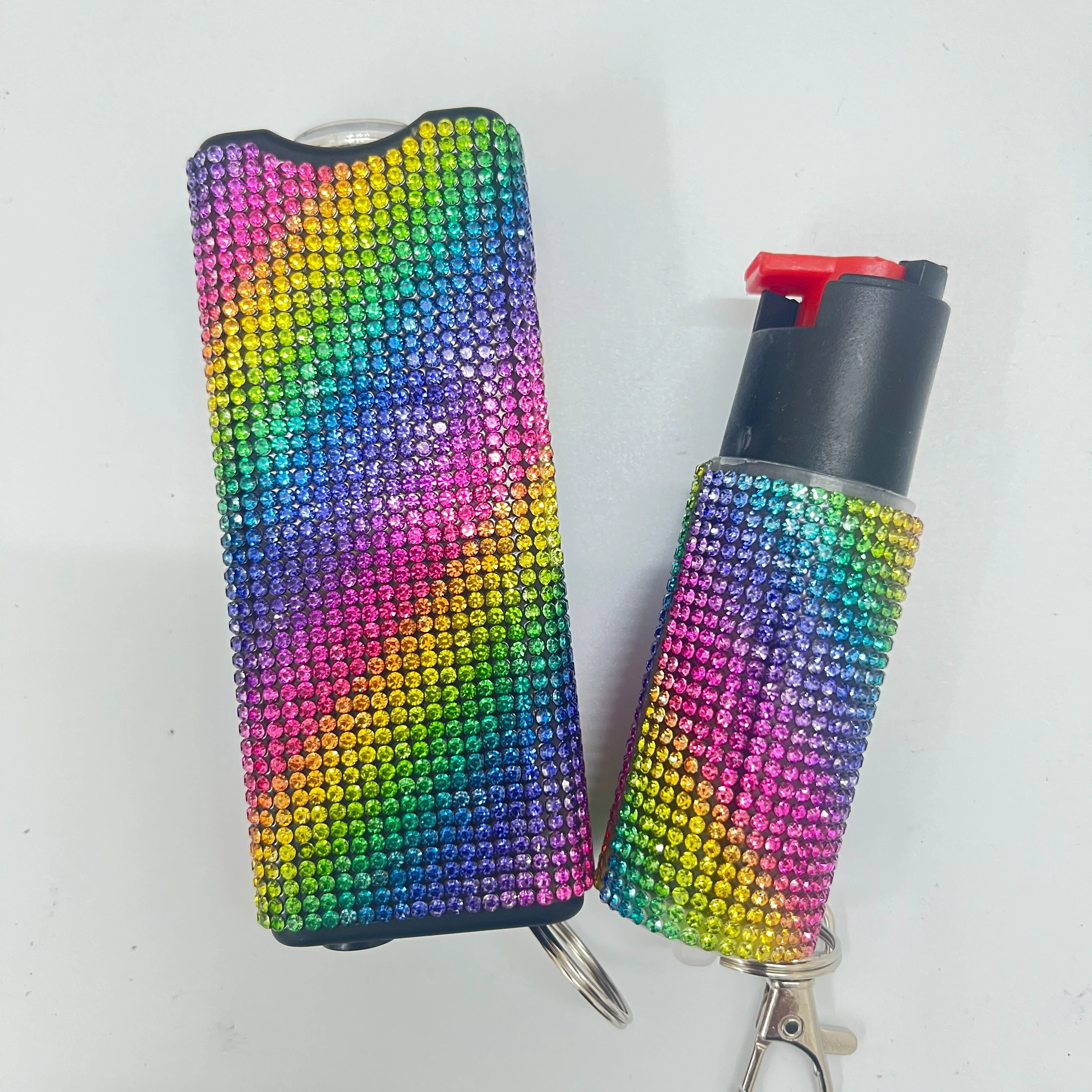 Self-defense multi-functional flashlight + spray keychain set for women.