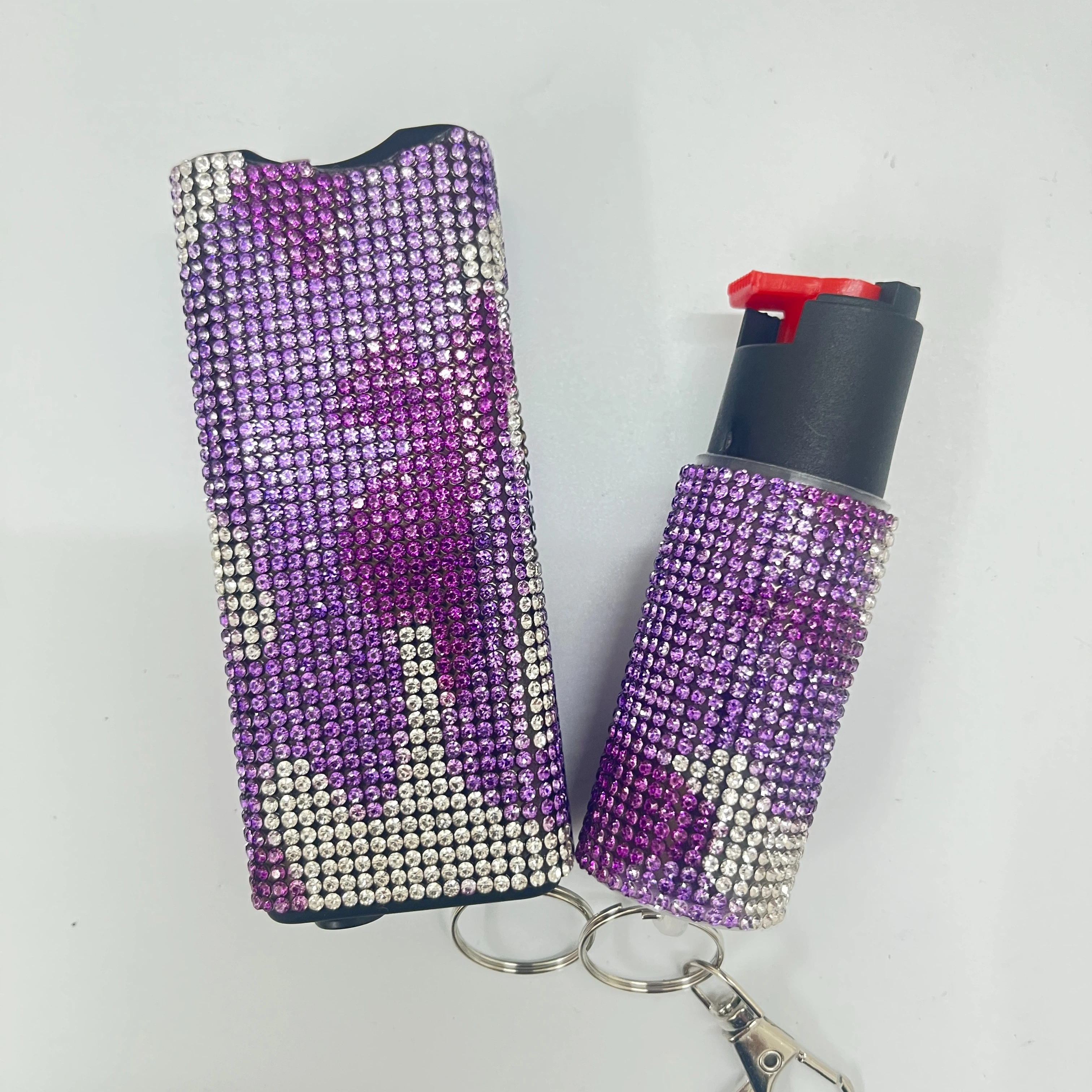 Self-defense multi-functional flashlight + spray keychain set for women.