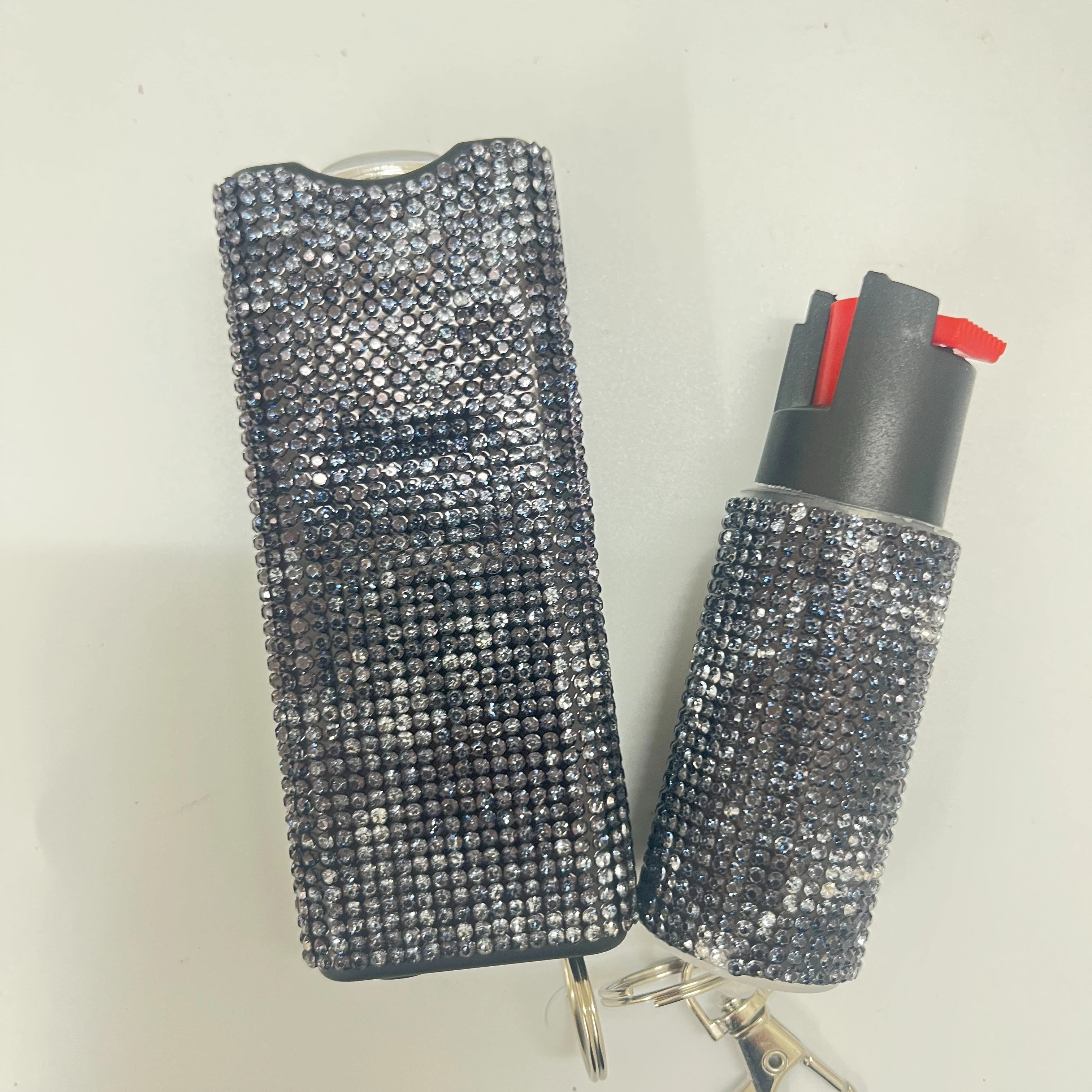 Self-defense multi-functional flashlight + spray keychain set for women.