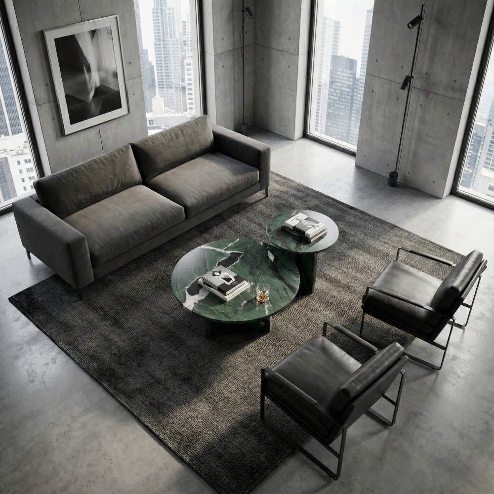 Industrial loft apartment aesthetic featuring green marble tables that add a touch of natural luxury to a concrete and urban modern living space.