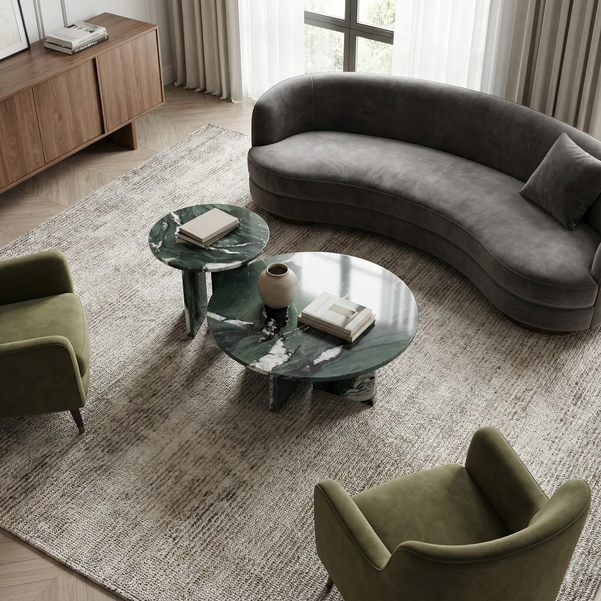 Living room layout inspiration: 2-piece round marble coffee table set arranged with a curved grey velvet sofa and green armchairs for a cohesive, organic look.