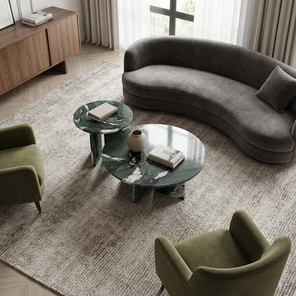 Living room layout inspiration: 2-piece round marble coffee table set arranged with a curved grey velvet sofa and green armchairs for a cohesive, organic look.