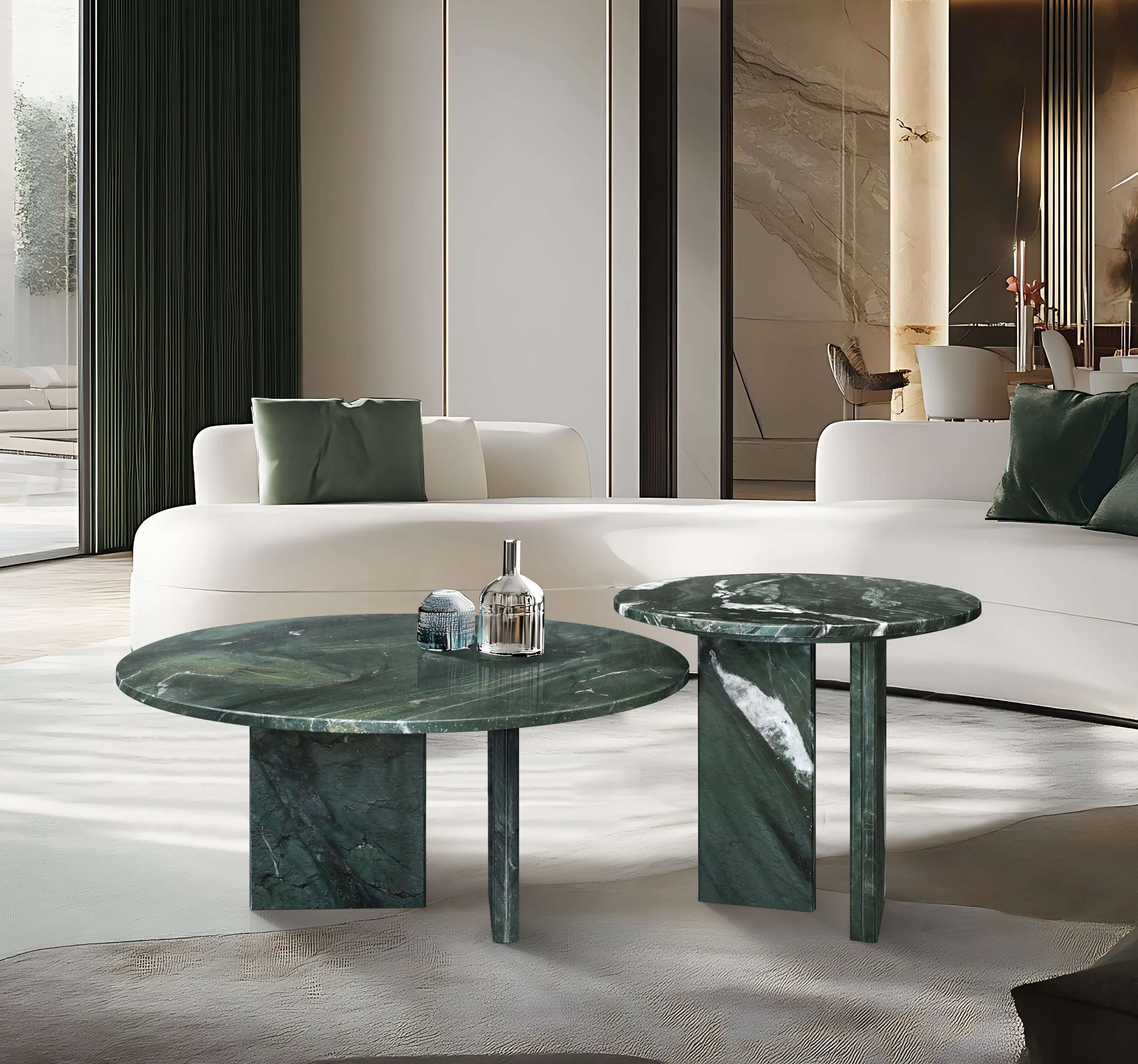 Luxury interior styling showing round emerald stone coffee tables with a polished finish, perfectly contrasting with a white minimalist sofa in a bright, high-end space.