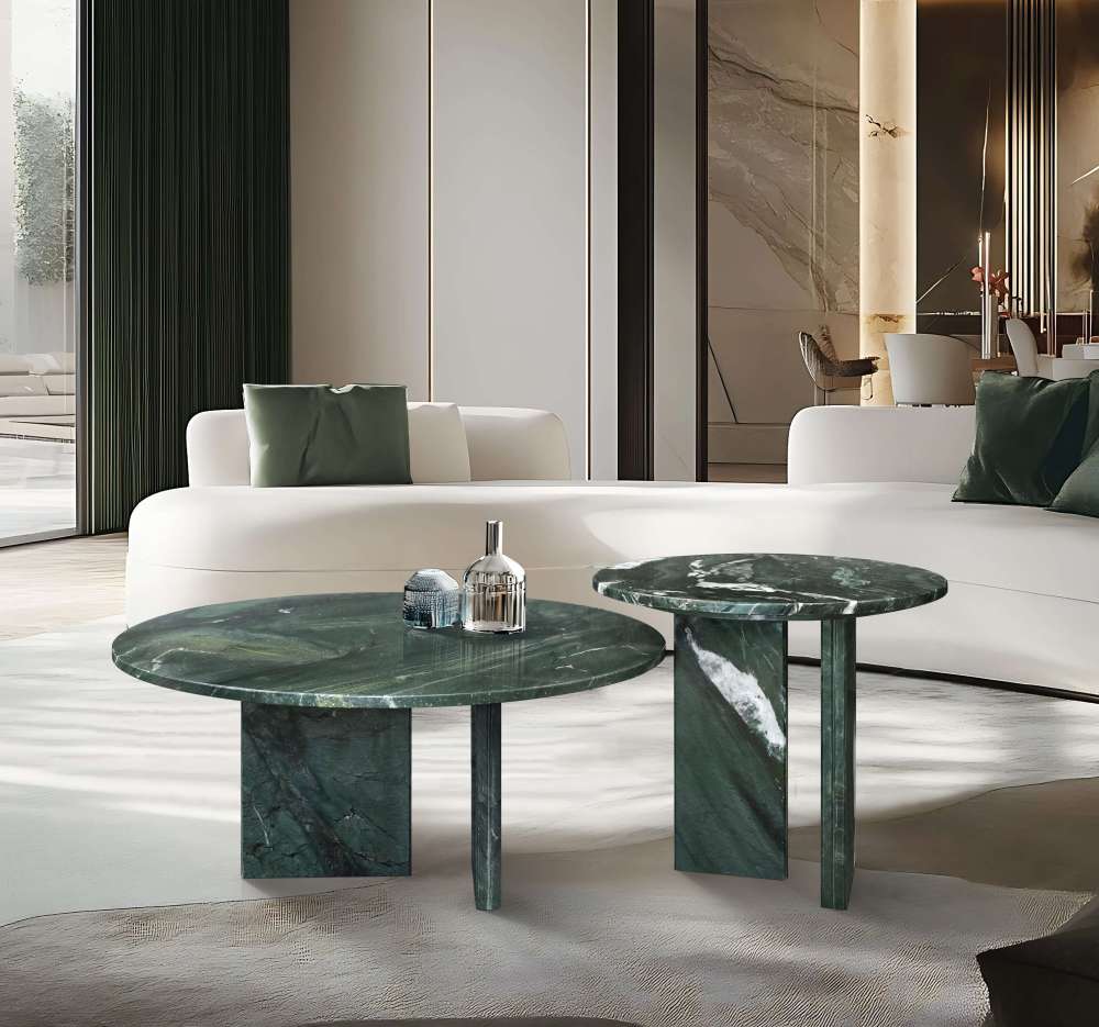 Luxury interior styling showing round emerald stone coffee tables with a polished finish, perfectly contrasting with a white minimalist sofa in a bright, high-end space.