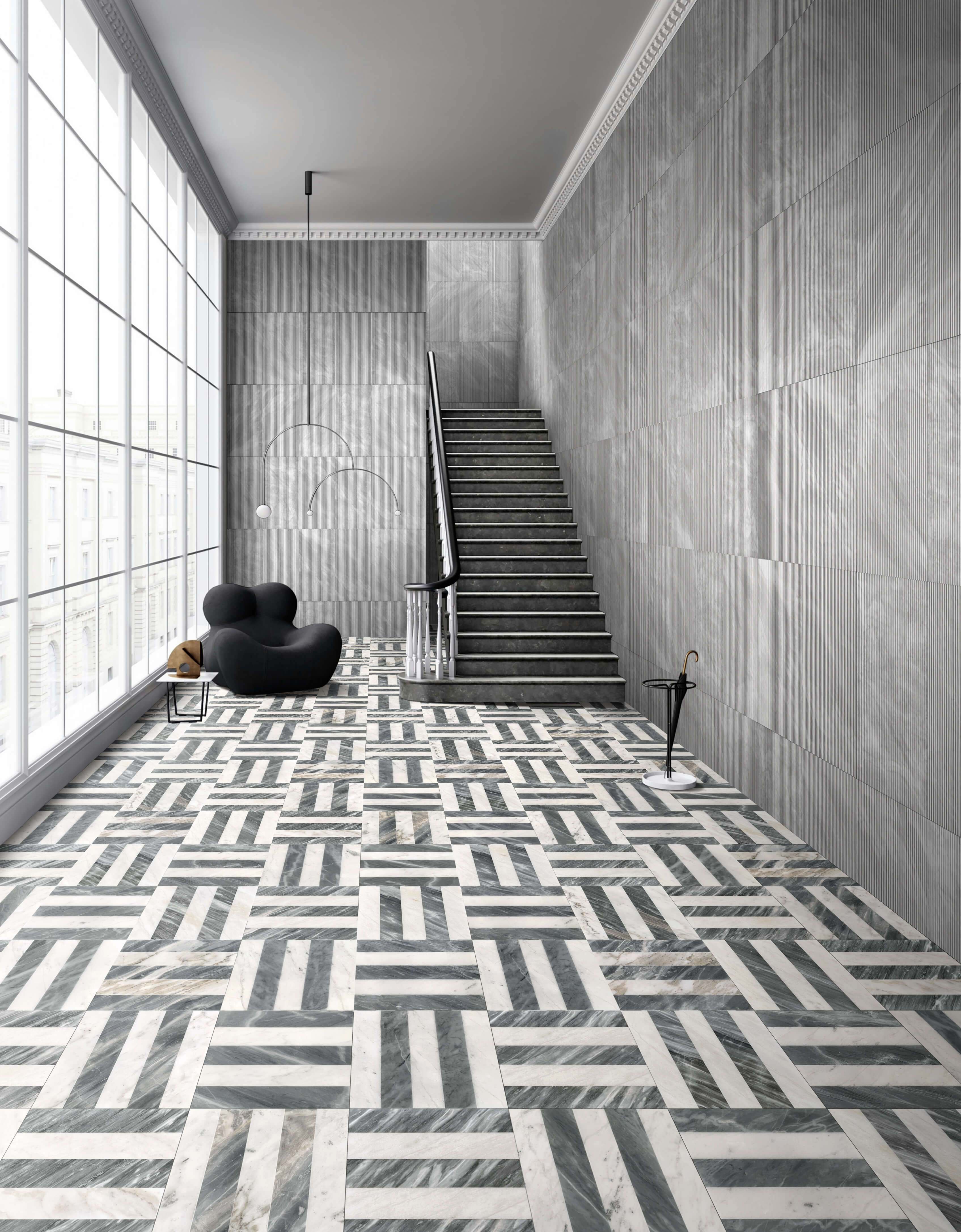 Modern architectural hallway featuring 12x12 polished Snow Mountain White and Carrara Gray waterjet floor tiles, perfectly coordinated with 12x24 Carrara Gray OL textured wall tiles.