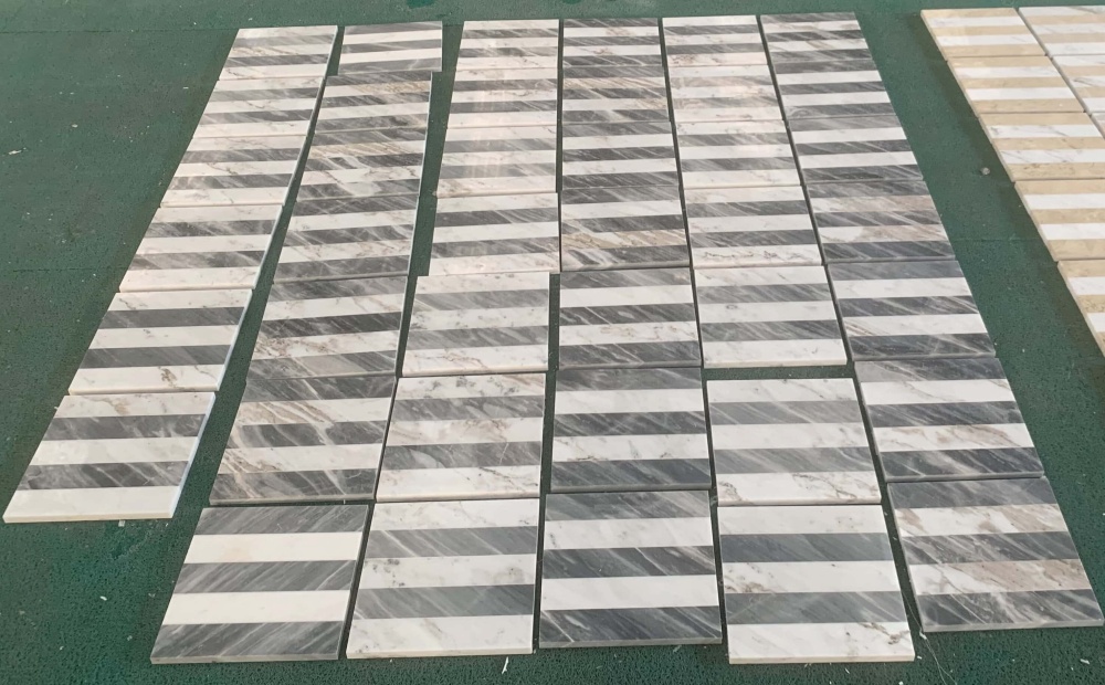 Factory dry lay quality inspection of Snow Mountain White and Carrara Gray marble tiles to ensure perfect pattern alignment and color consistency.