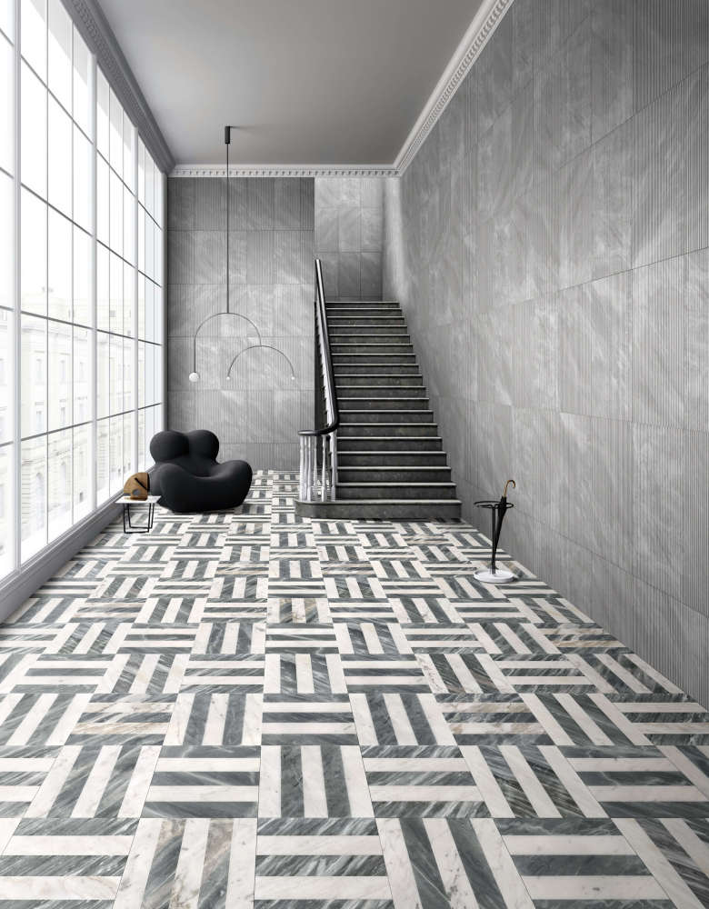 Modern architectural hallway featuring 12x12 polished Snow Mountain White and Carrara Gray waterjet floor tiles, perfectly coordinated with 12x24 Carrara Gray OL textured wall tiles.