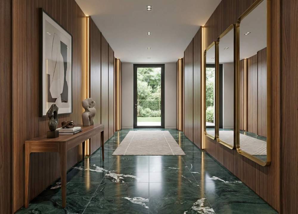 Long hallway corridor featuring polished Diamond Green marble flooring that reflects natural light, paired with warm wood wall paneling and mirrors.