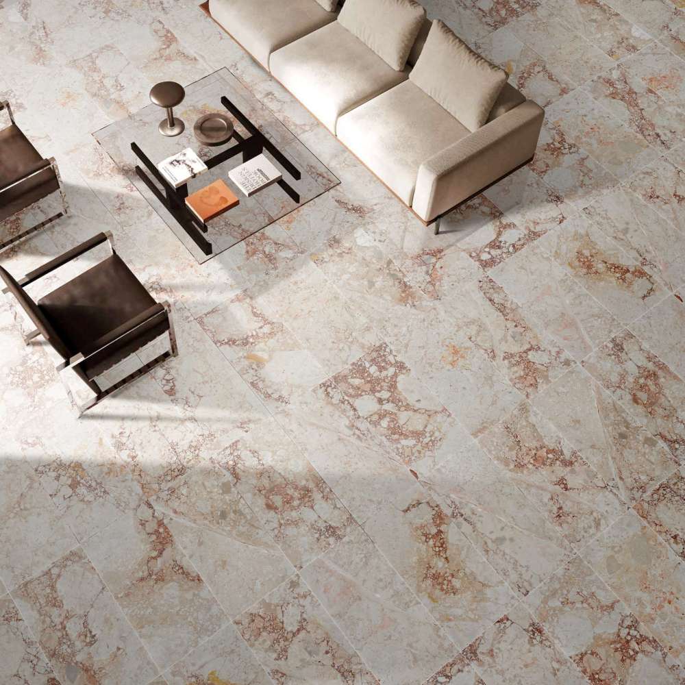 High-angle view of a living area showing the rich texture and color variation of installed Diamond Pink marble tiles under natural light.