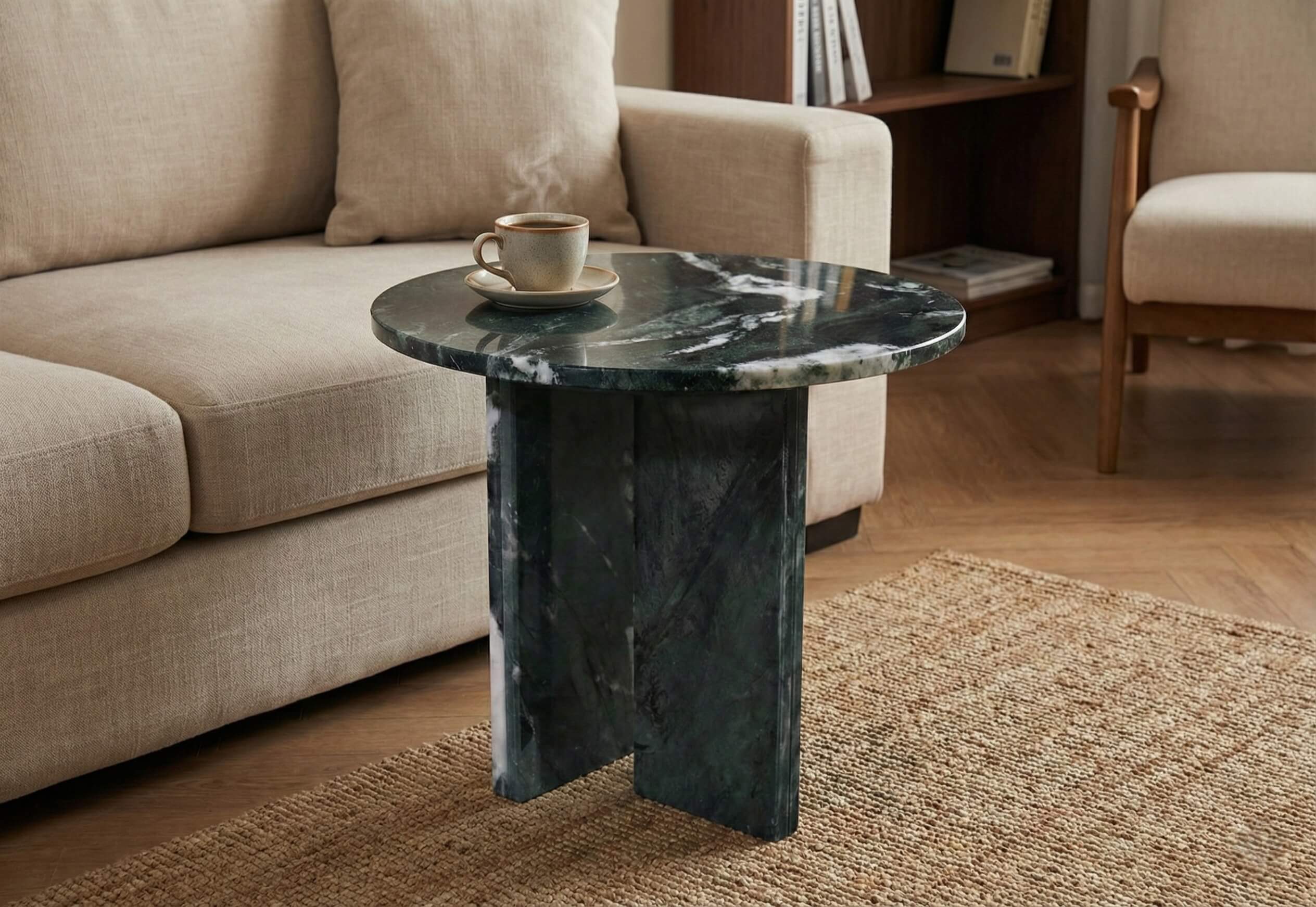Elegant dark green marble table positioned at the sofa side, showcasing the premium polished stone surface and hot coffee.