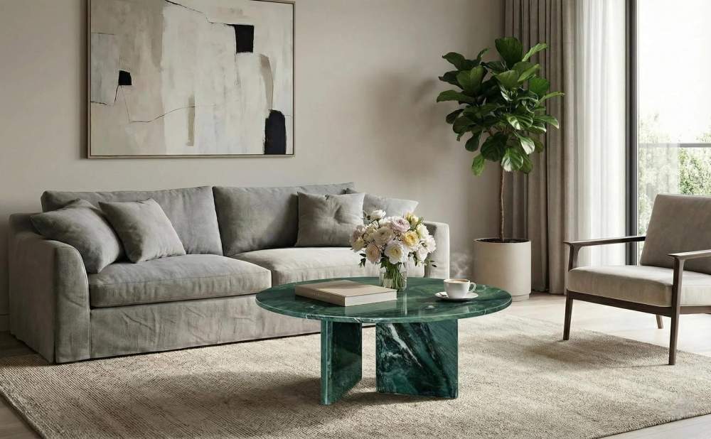 A contemporary living room featuring a grey sofa paired with the Diamond Green marble coffee table, creating a sophisticated monochromatic look.