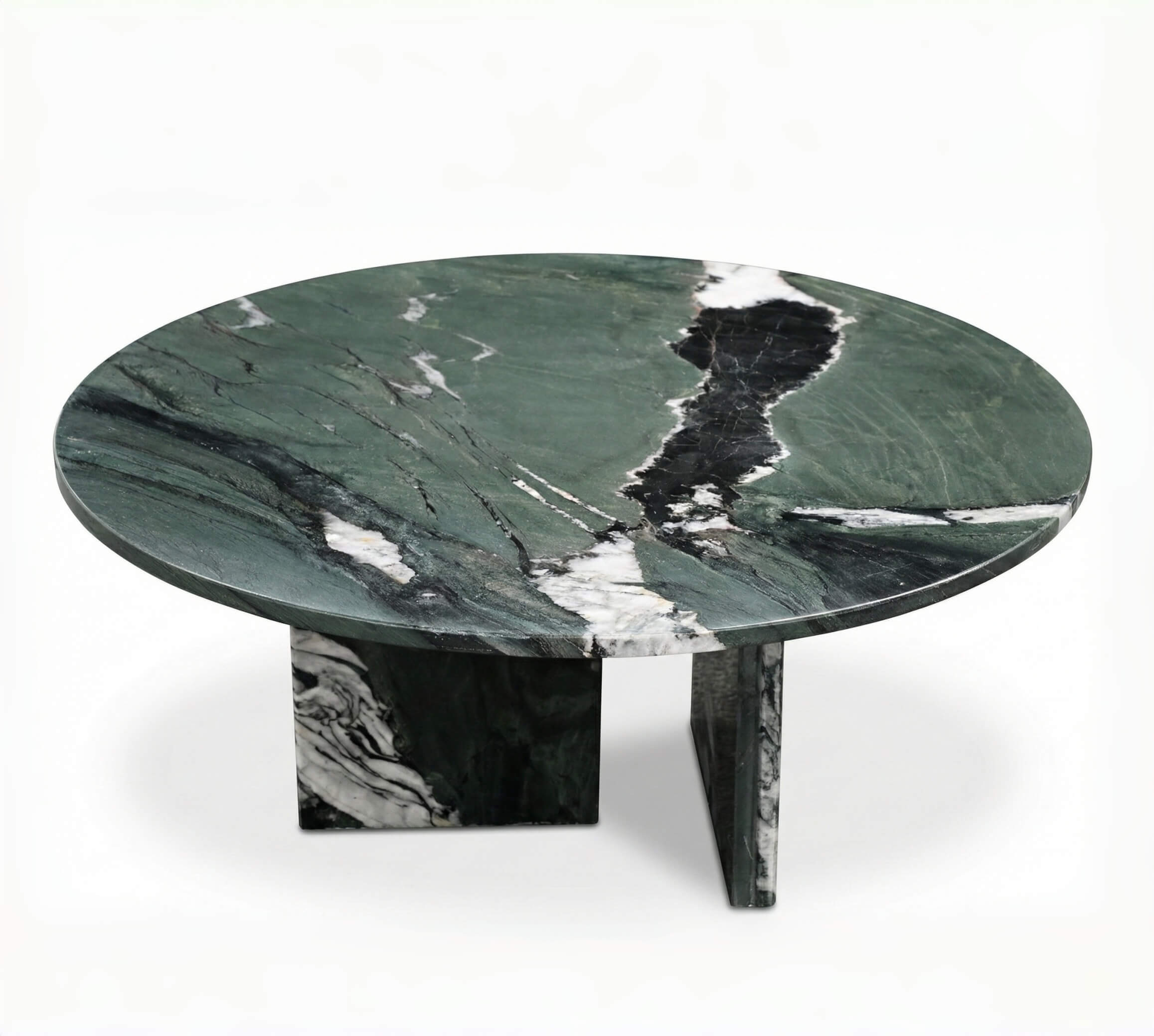 Studio shot of a round green marble coffee table displaying intricate white and black mineral veins, showcasing the uniqueness of natural stone.