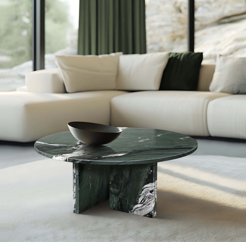 Bright luxury lounge area with a white sectional sofa, highlighting the vivid green veins of the round marble coffee table in natural light.